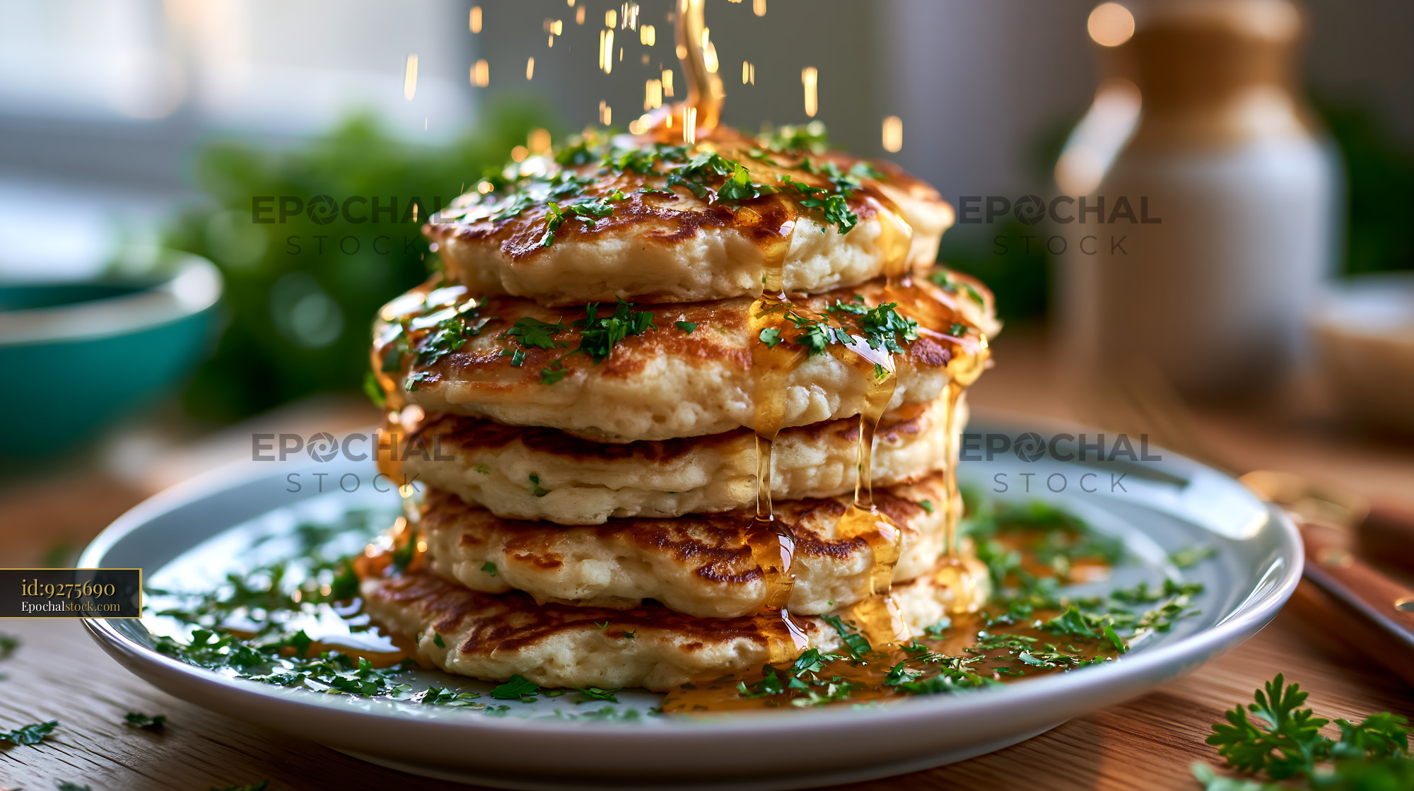 Watermarked full-resolution preview of Fluffy pancakes stacked high with syrup and herbs on a plate