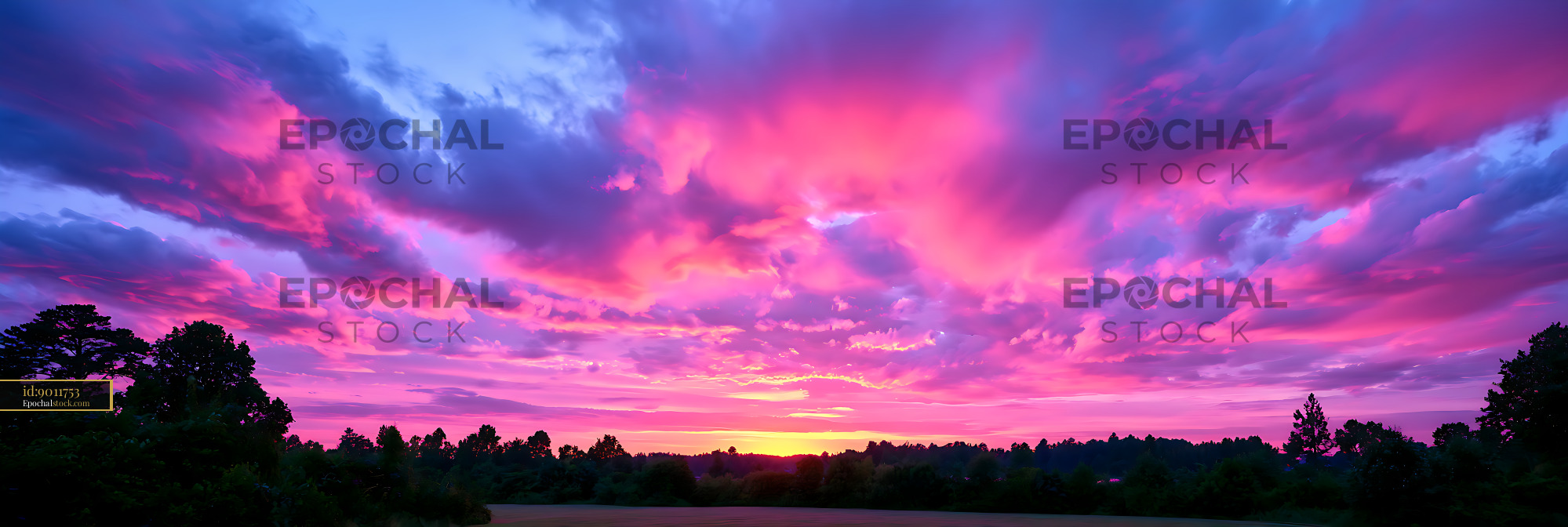 Watermarked full-resolution preview of Dramatic colorful sunset above a tree-lined horizon