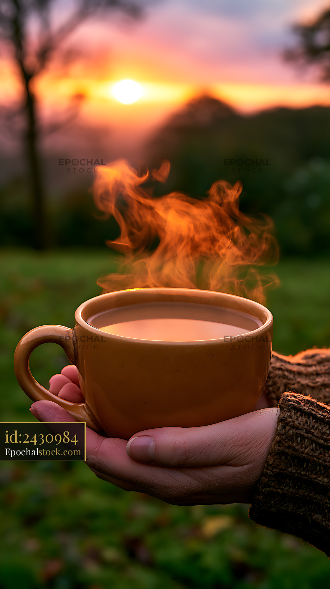 Watermarked full-resolution preview of Hand holding a steaming coffee cup against a sunset