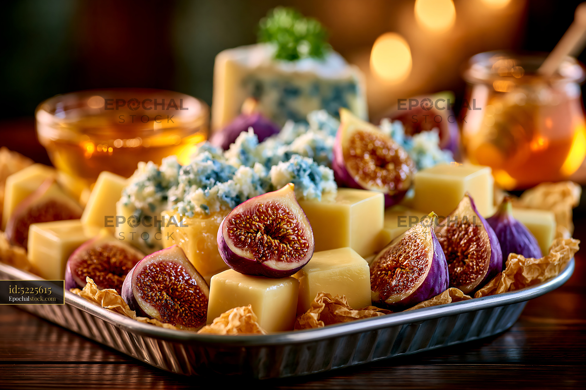 Watermarked full-resolution preview of Gourmet cheese platter with fresh figs
