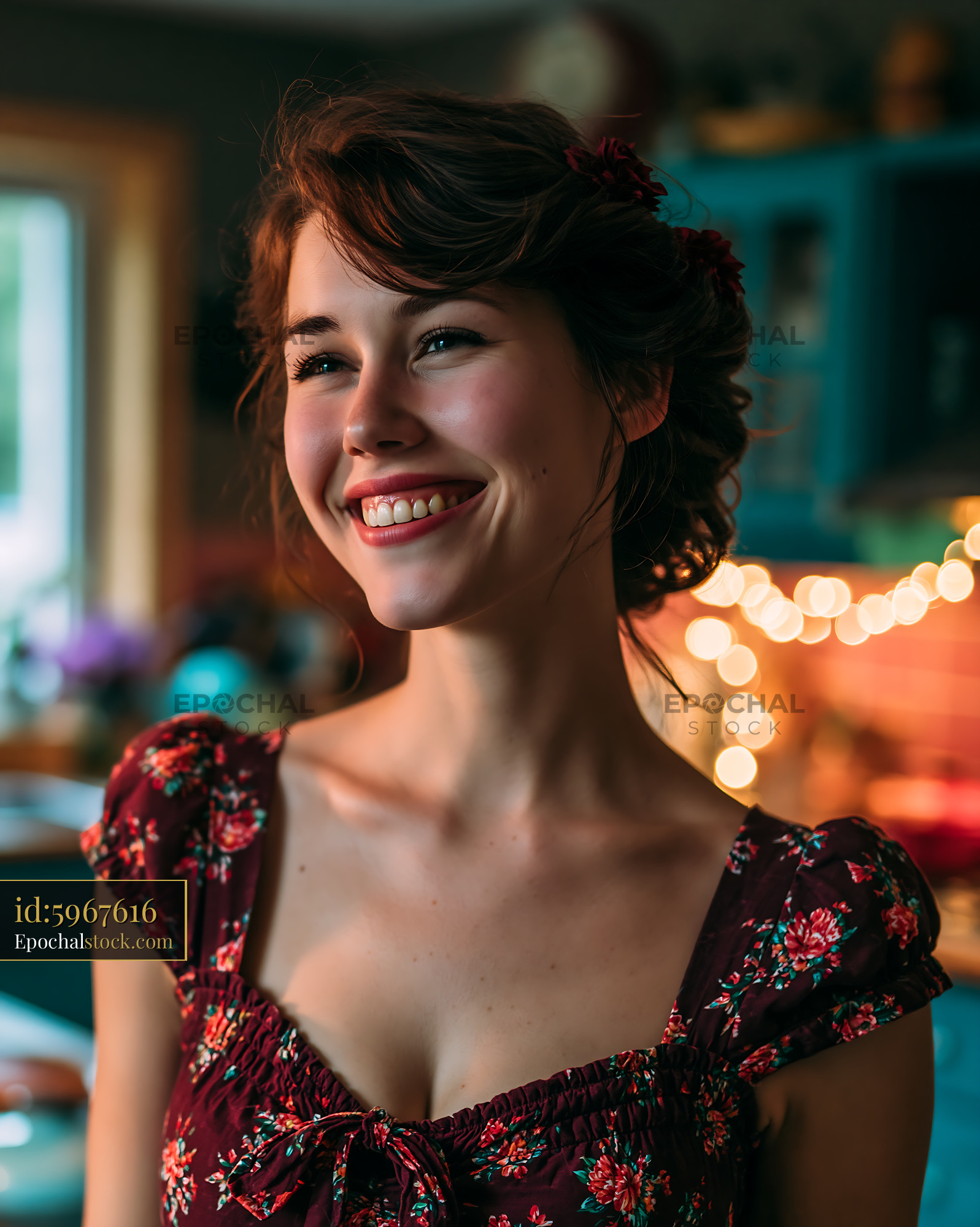 Watermarked full-resolution preview of Smiling woman in a dimly lit kitchen with decorative lights