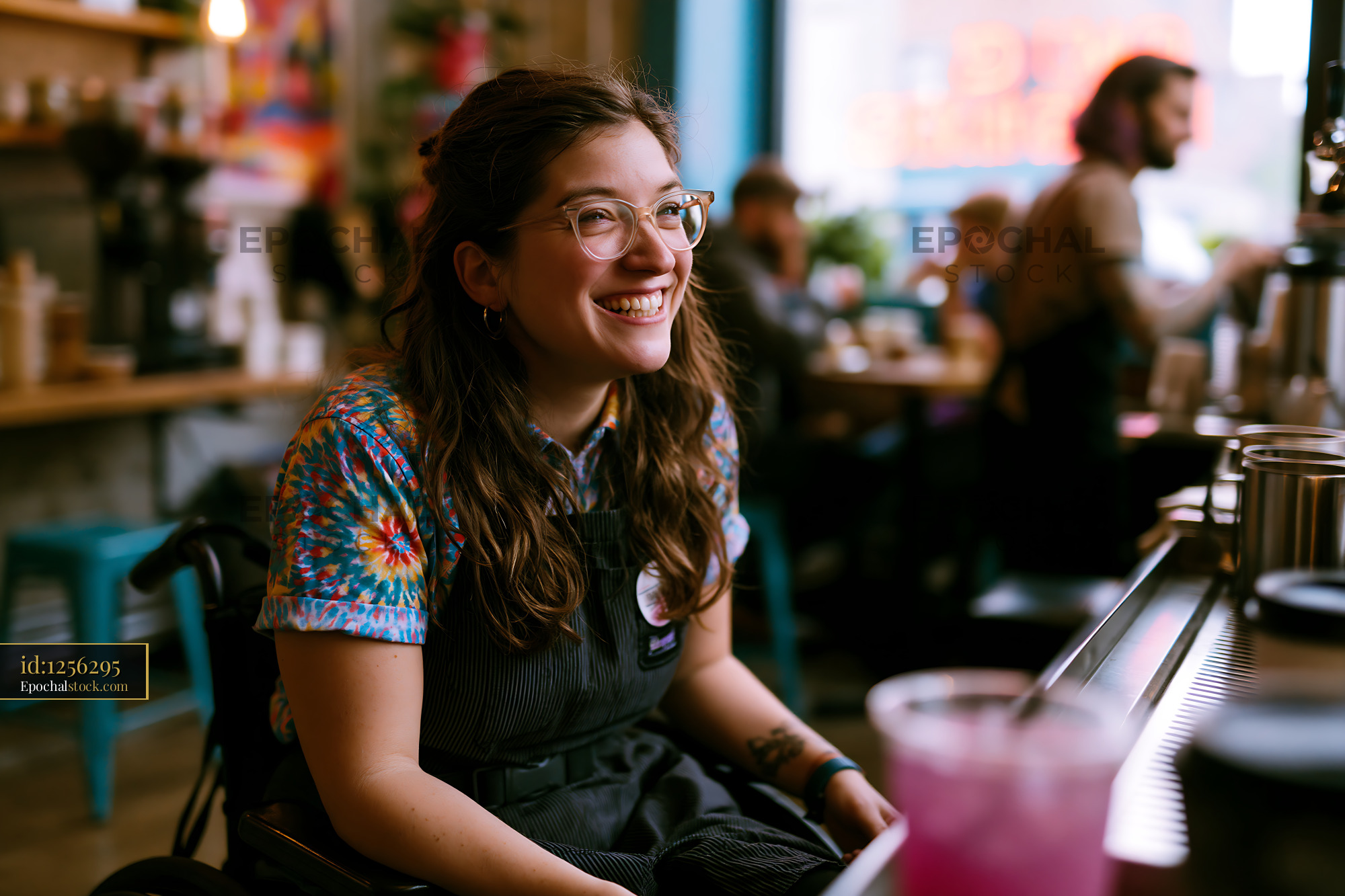 Watermarked full-resolution preview of Woman in a wheelchair smiles while working in a cafe