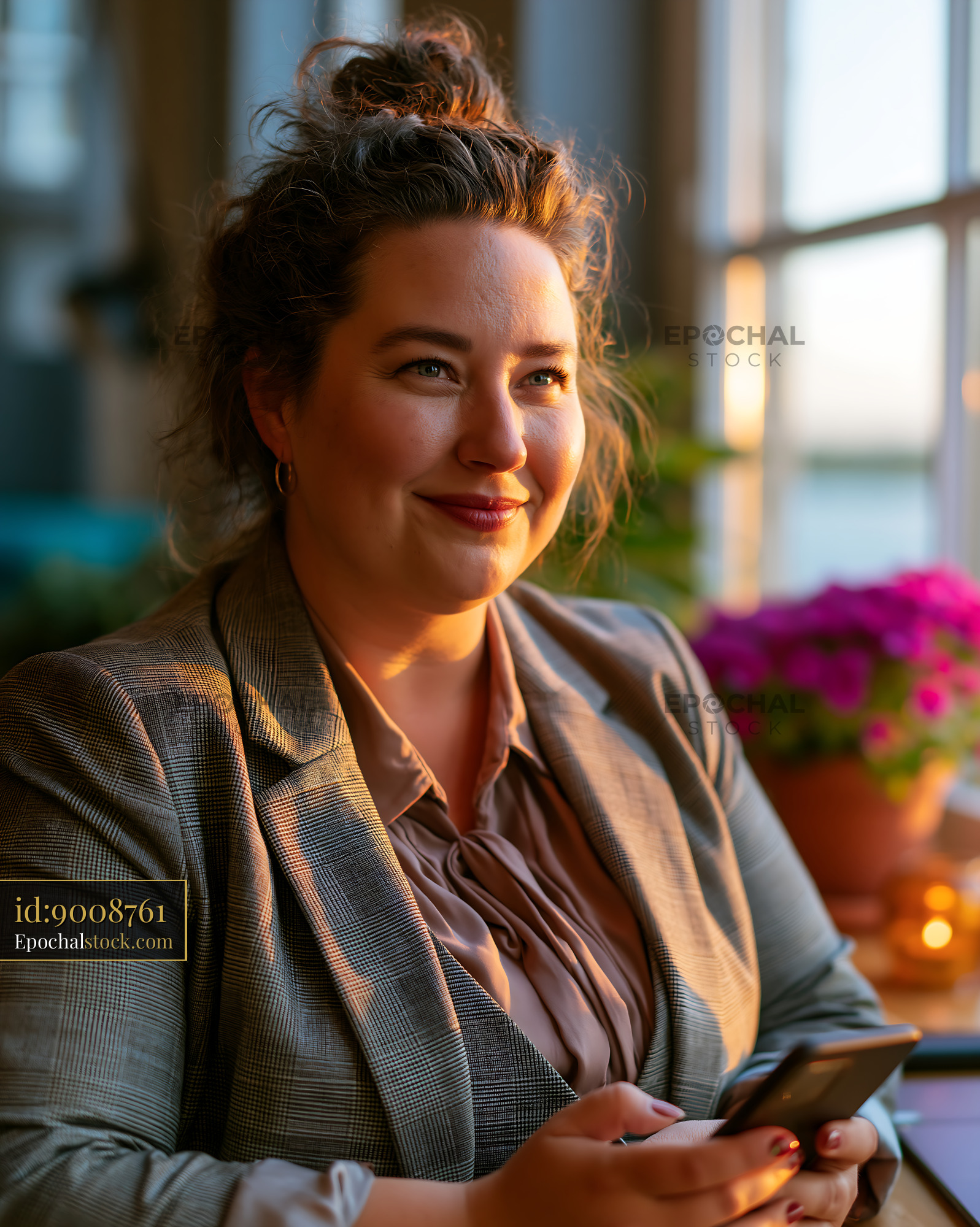 Watermarked full-resolution preview of Woman sitting in a cafe looking at her phone during sunset