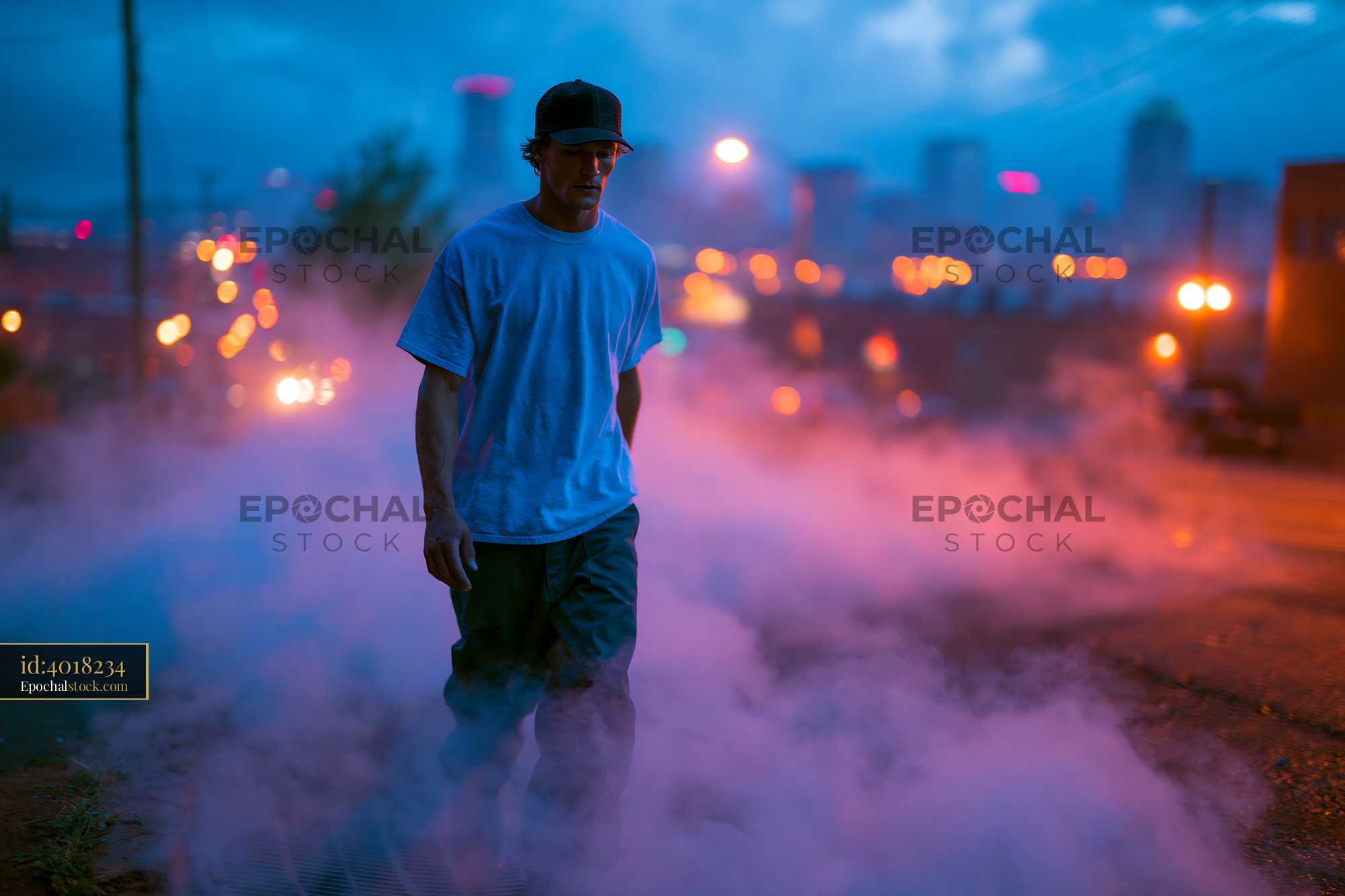 Skater Man Walking Through Fog in Urban Setting at Dusk - stock photo