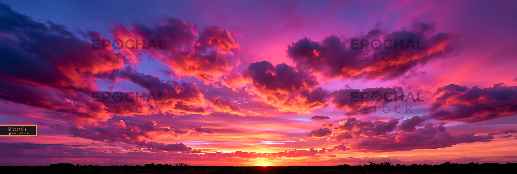 Watermarked full-resolution preview of Colorful dramatic sunset clouds above a silhouetted horizon