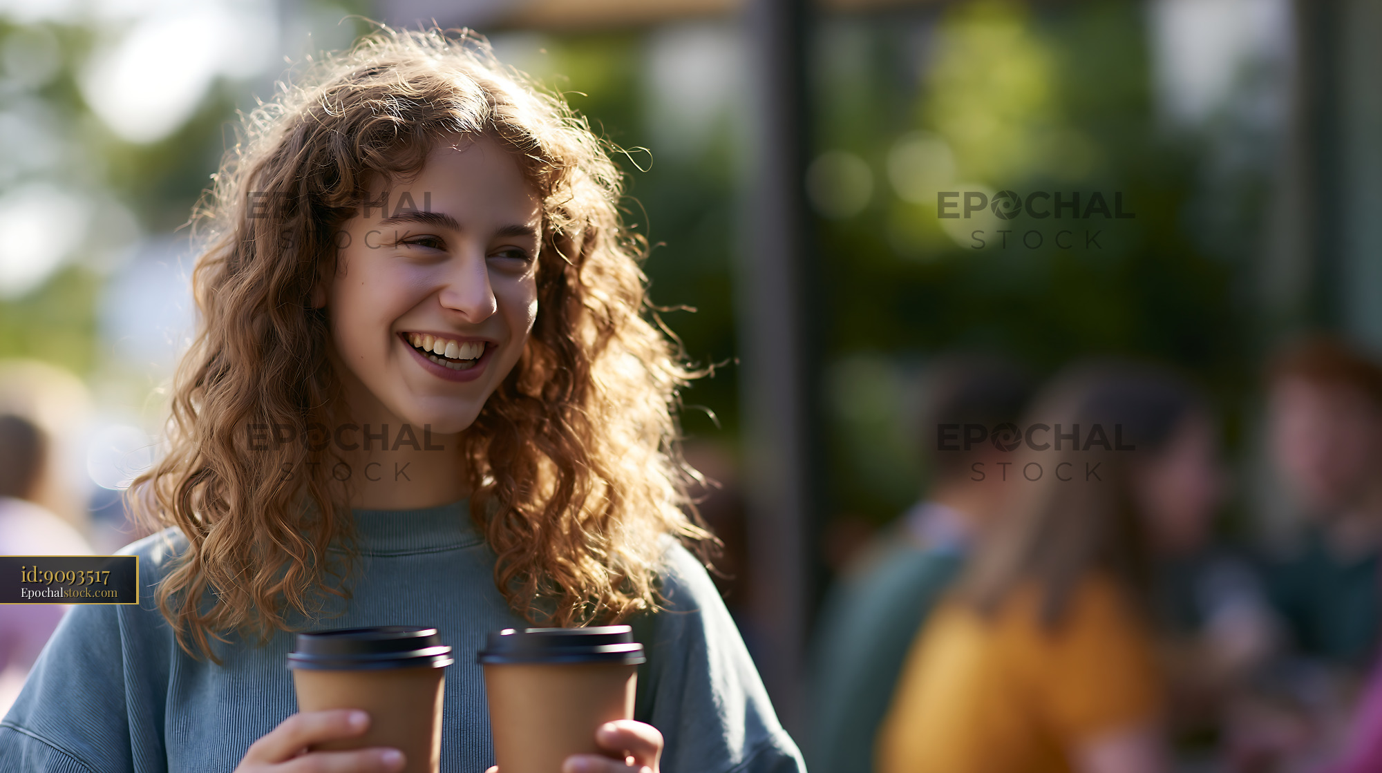 Watermarked full-resolution preview of Young woman holding two coffee cups outdoors