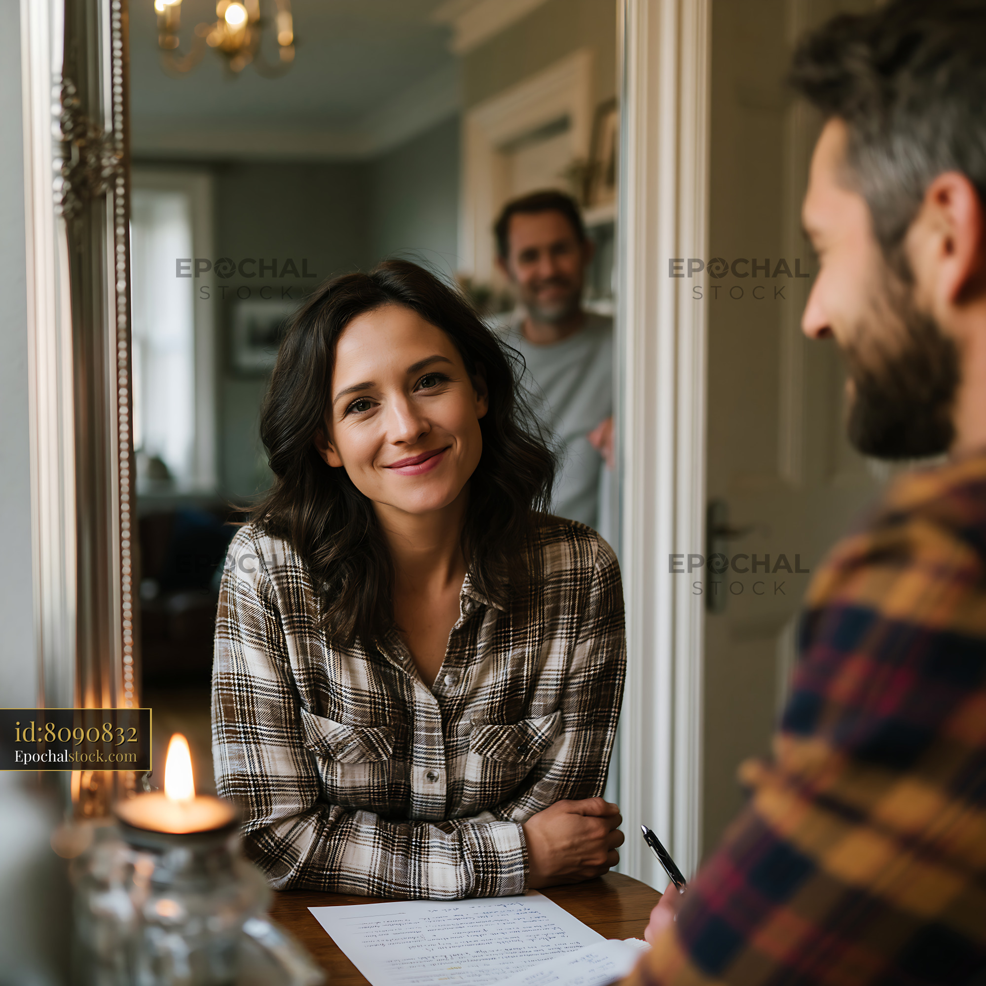 Watermarked full-resolution preview of Couple discussing plans at a cozy home setting