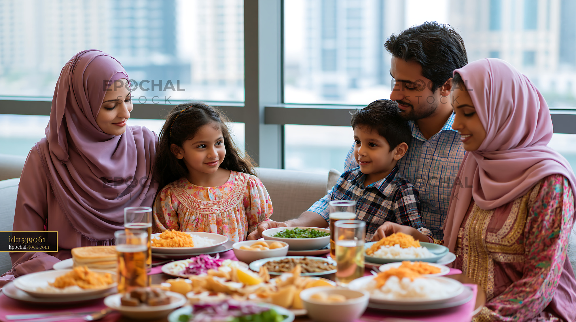 Family Sharing an Iftar Dinner by the Window in Dubai - stock photo