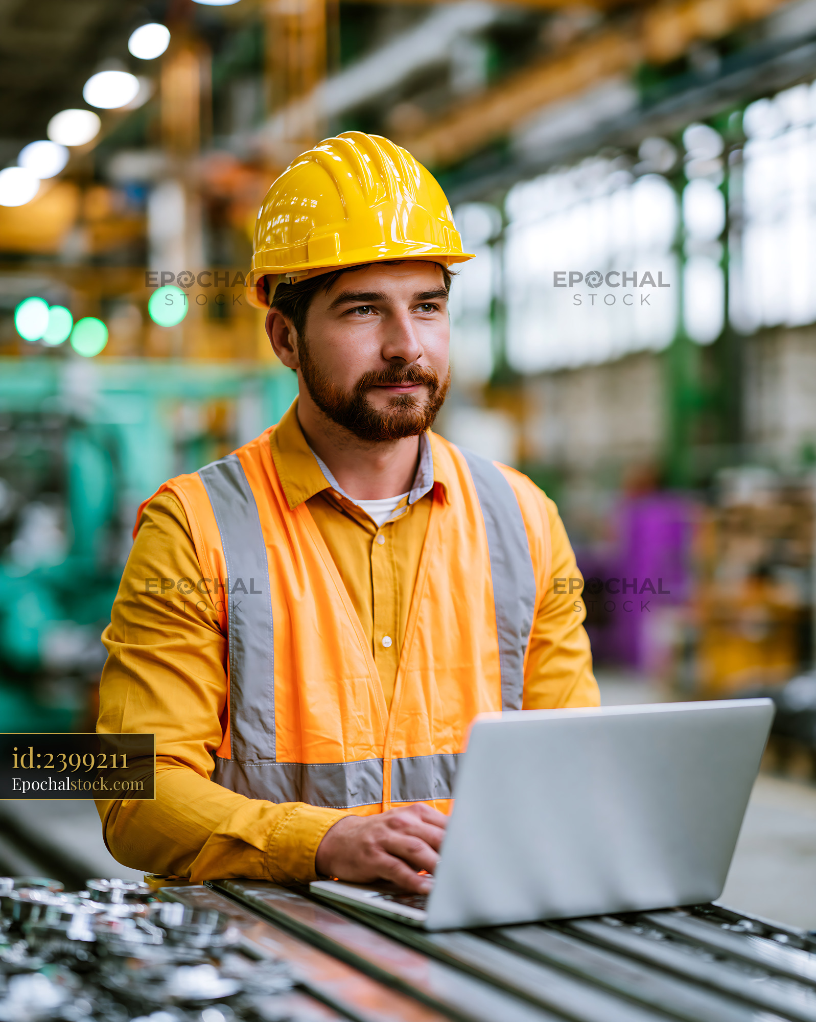 Watermarked full-resolution preview of Worker with laptop in industrial facility