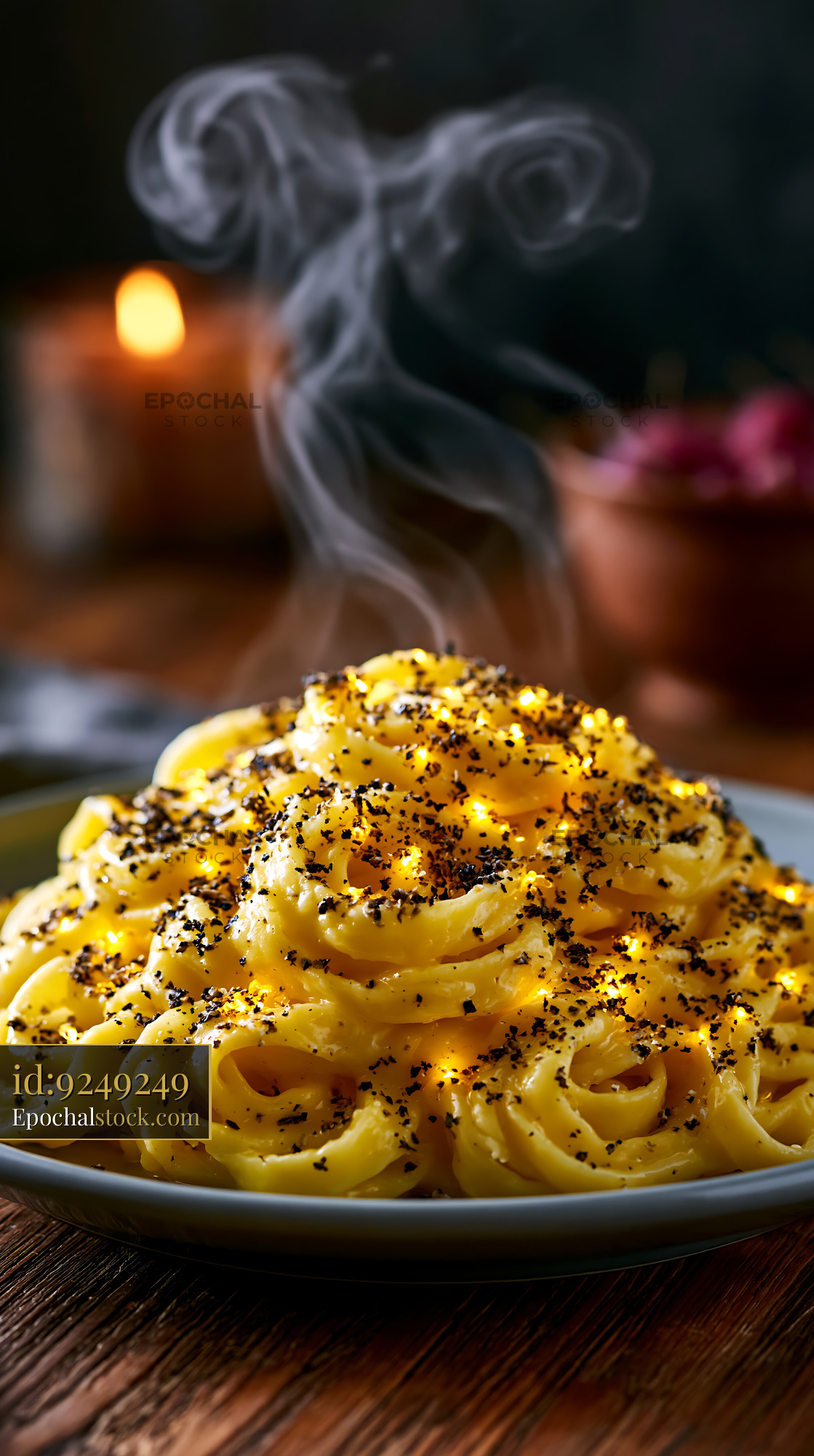 Watermarked full-resolution preview of Creamy pasta dish with black pepper and steam rising