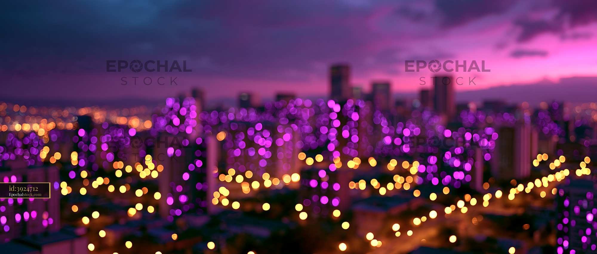 City Skyline Glows With Purple Lights at Sunset Over Buildings - stock photo