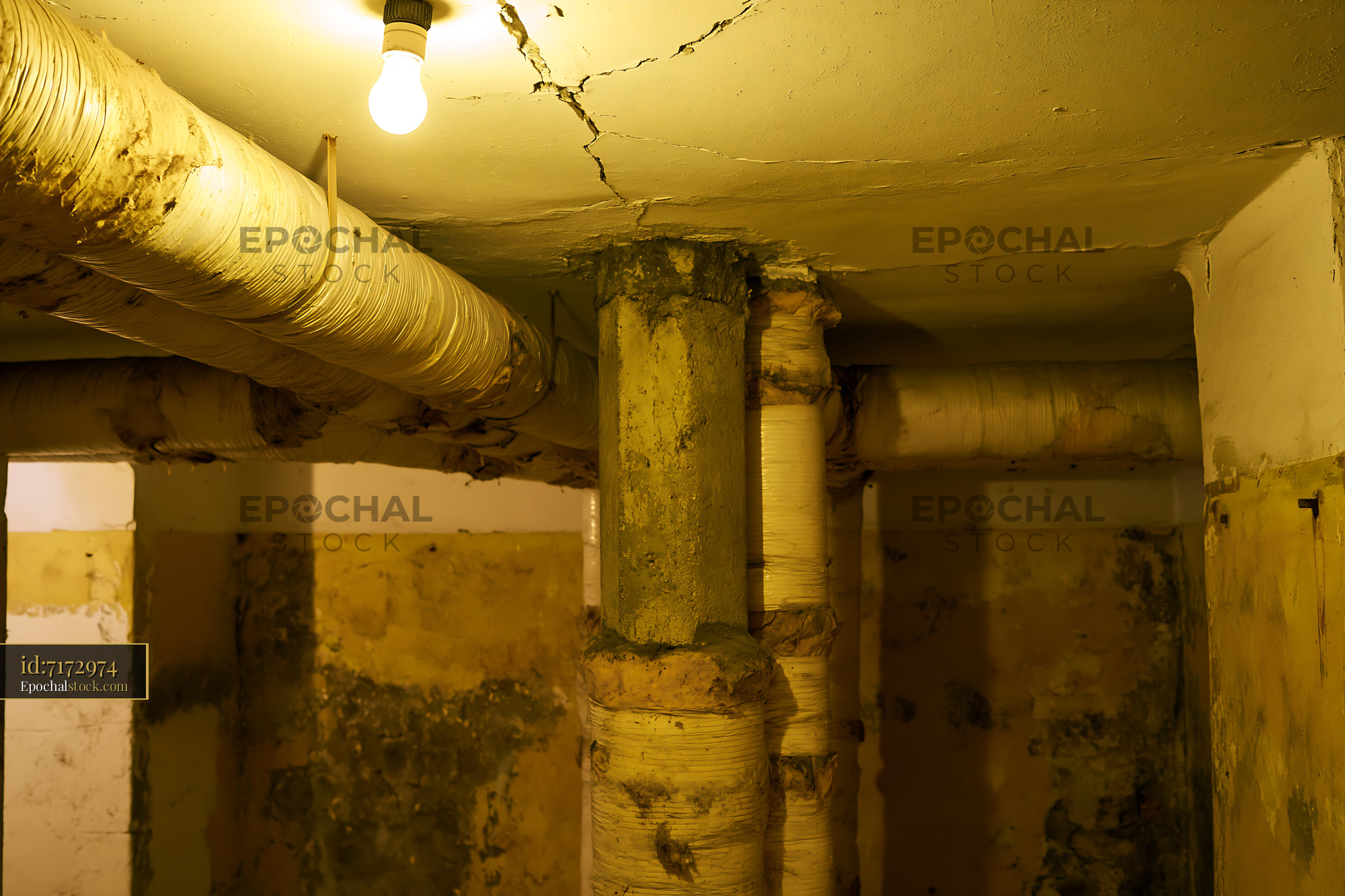 Watermarked full-resolution preview of Old basement interior with pipes and damaged ceiling