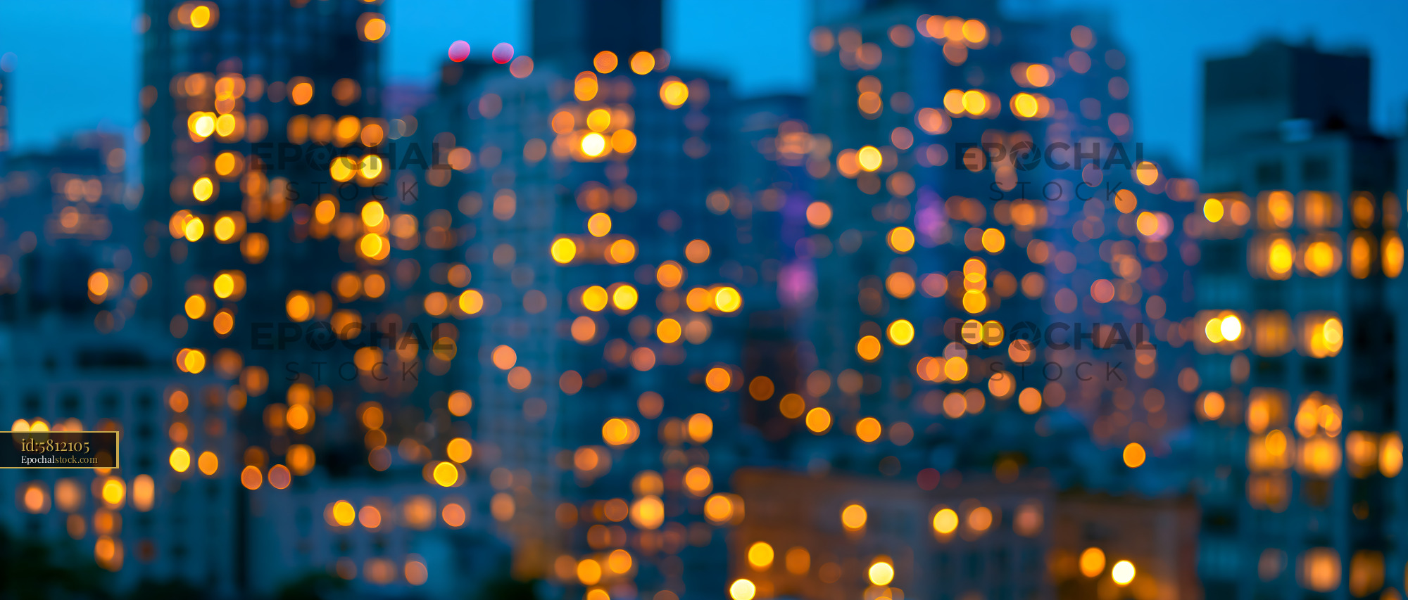 Watermarked full-resolution preview of City skyline at dusk with blurred lights shining