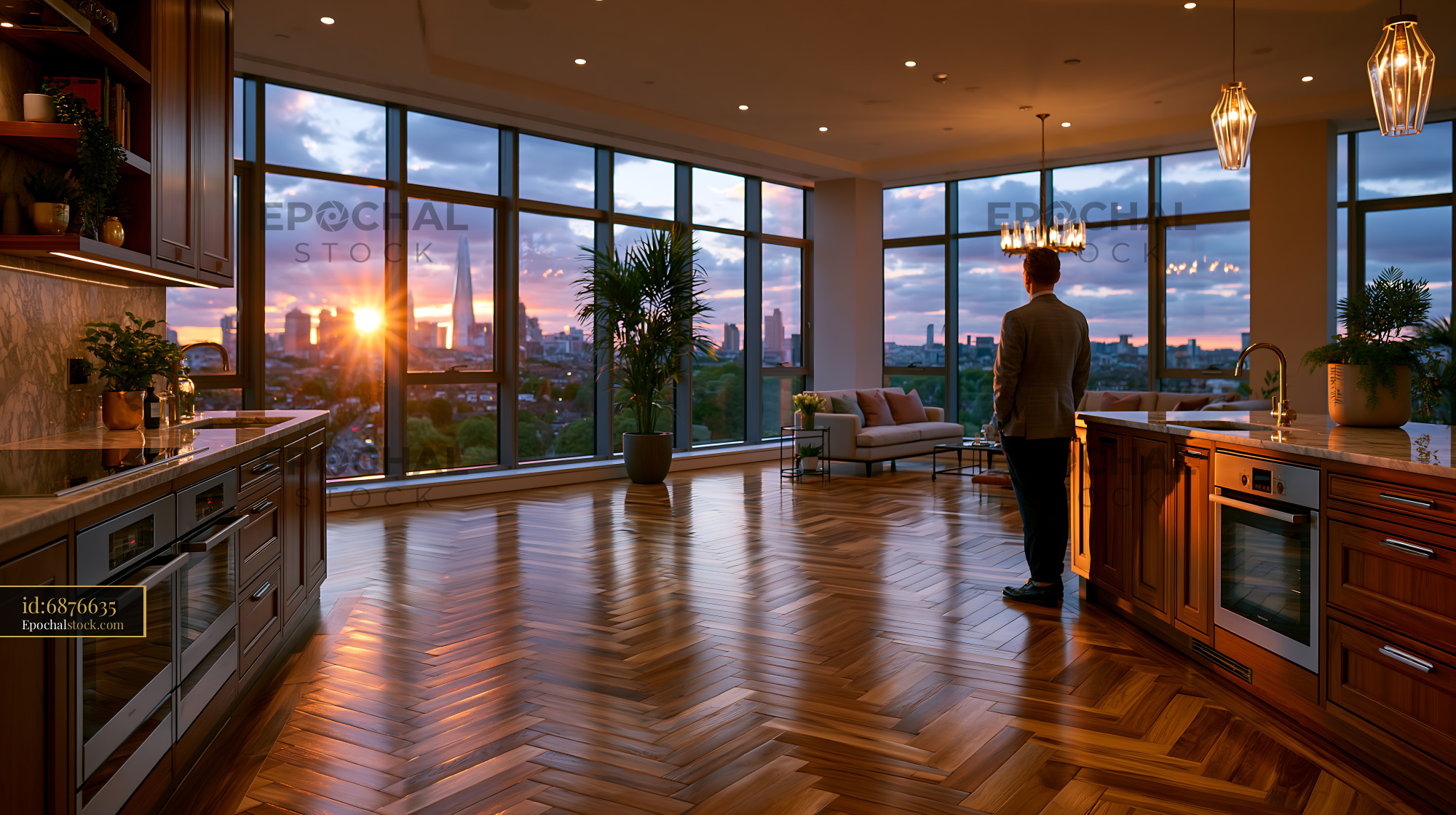 Watermarked full-resolution preview of Man standing in modern kitchen with sunset view in city