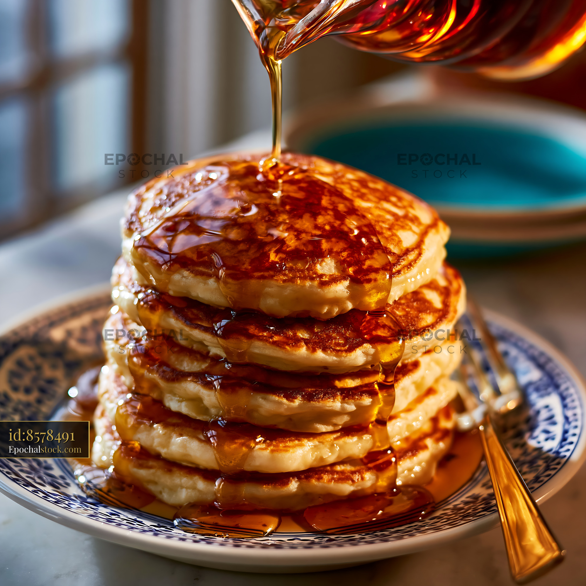 Watermarked full-resolution preview of Golden syrup pouring over a pancake stack