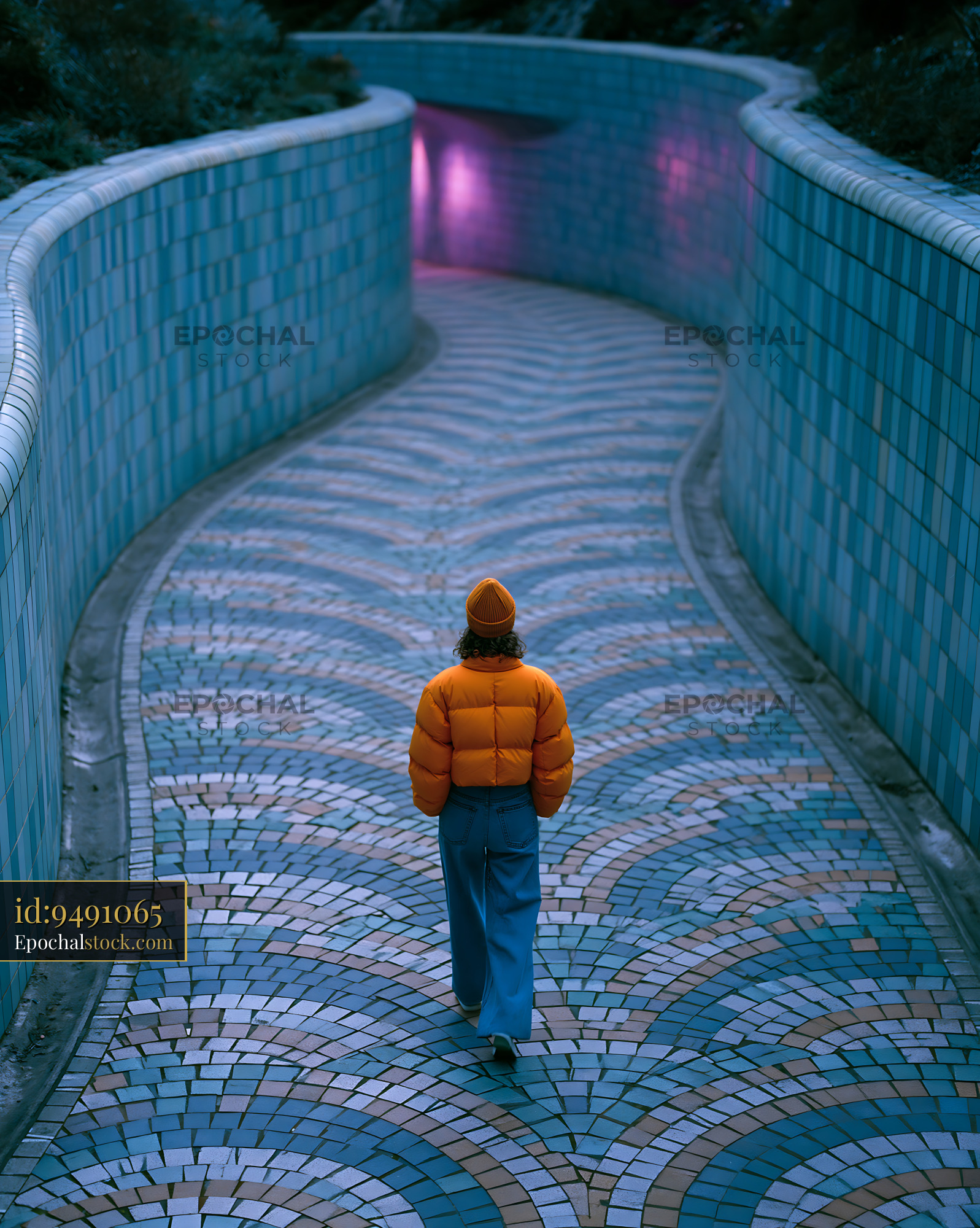 Watermarked full-resolution preview of Person walking on a winding path with colorful tiles at night
