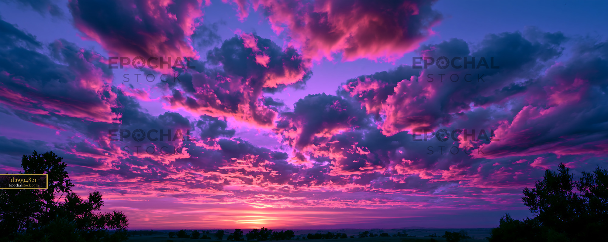 Watermarked full-resolution preview of Colorful sunset clouds above a rural horizon