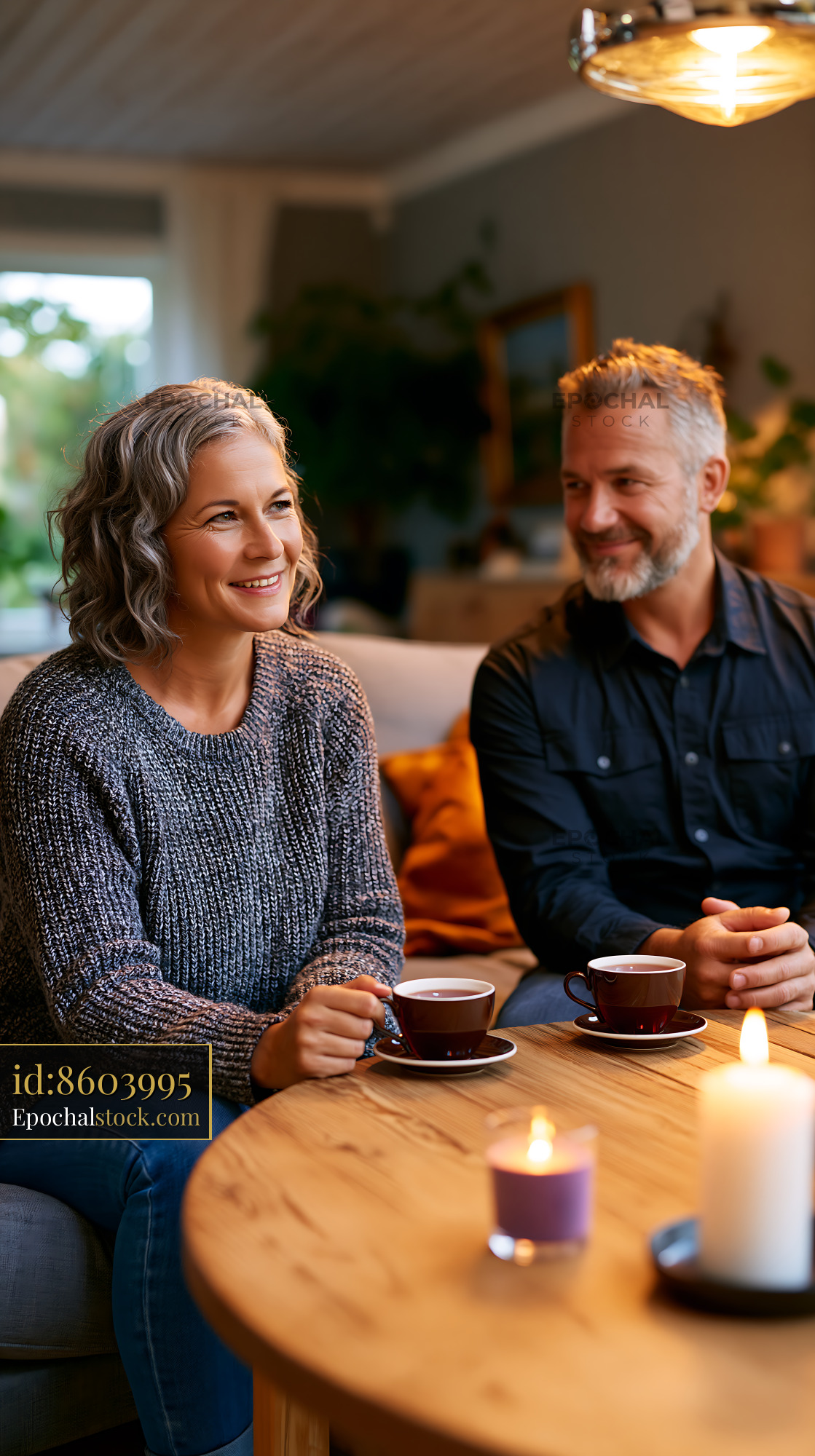 Watermarked full-resolution preview of Smiling couple sharing coffee in a cozy home