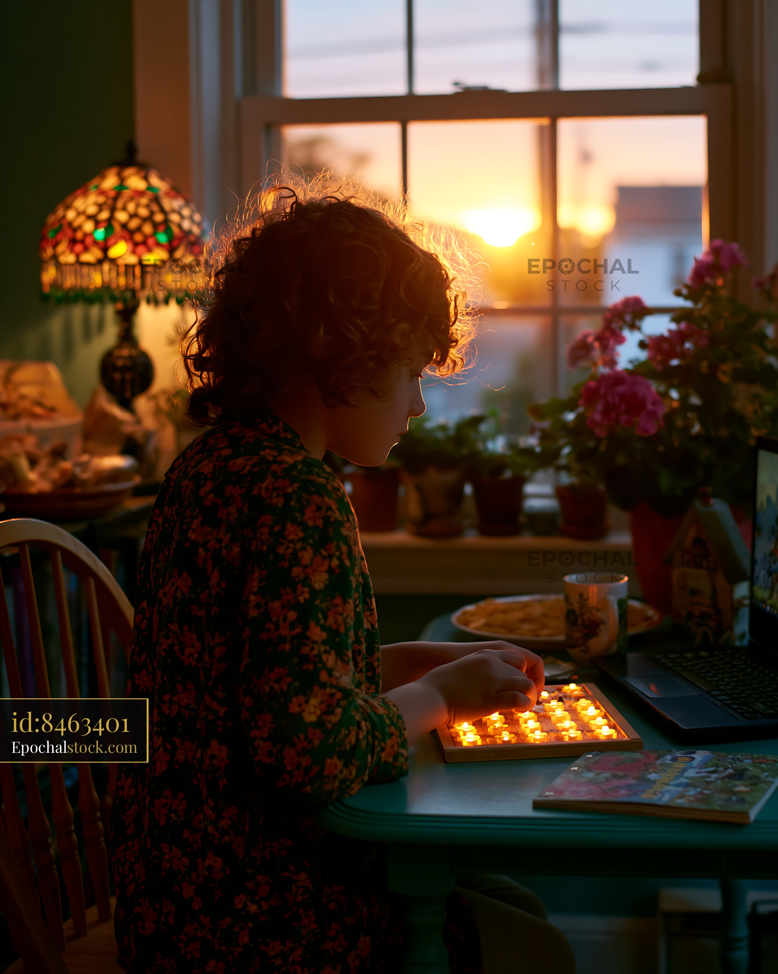 Watermarked full-resolution preview of One person arranging candles in a warm home interior