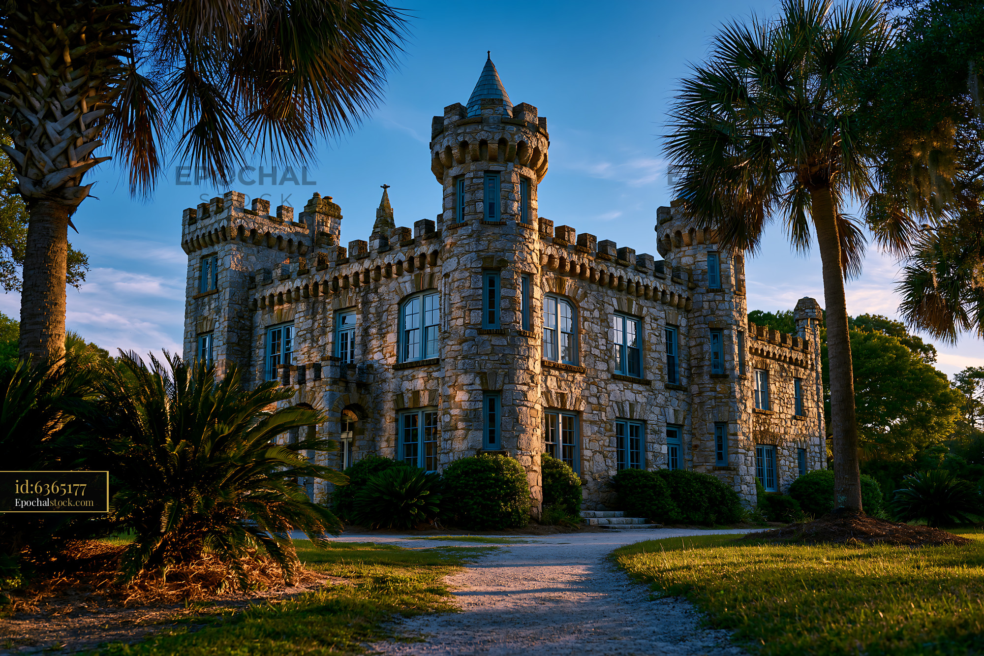 Watermarked full-resolution preview of Old stone castle with turrets surrounded by greenery