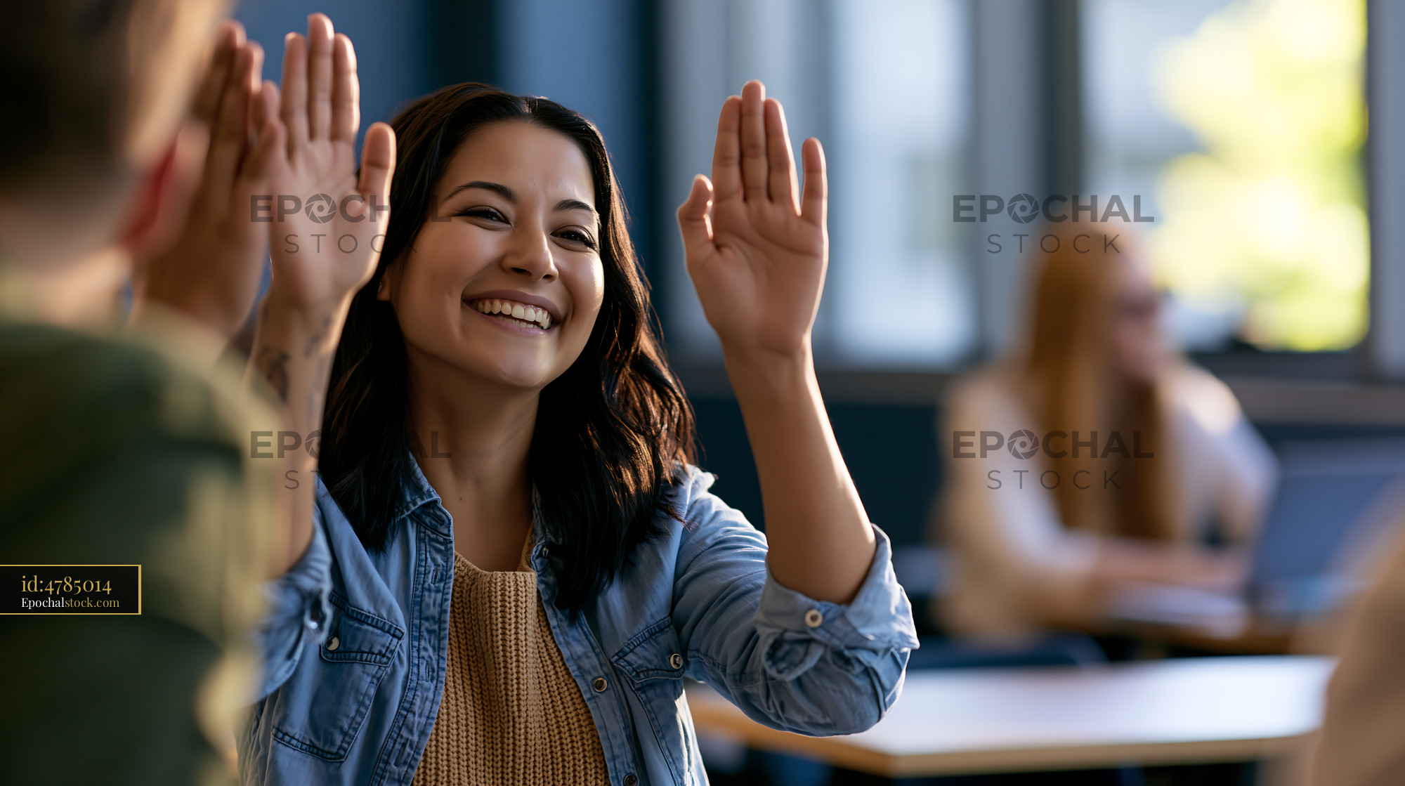 Watermarked full-resolution preview of Woman raises hand in classroom during discussion