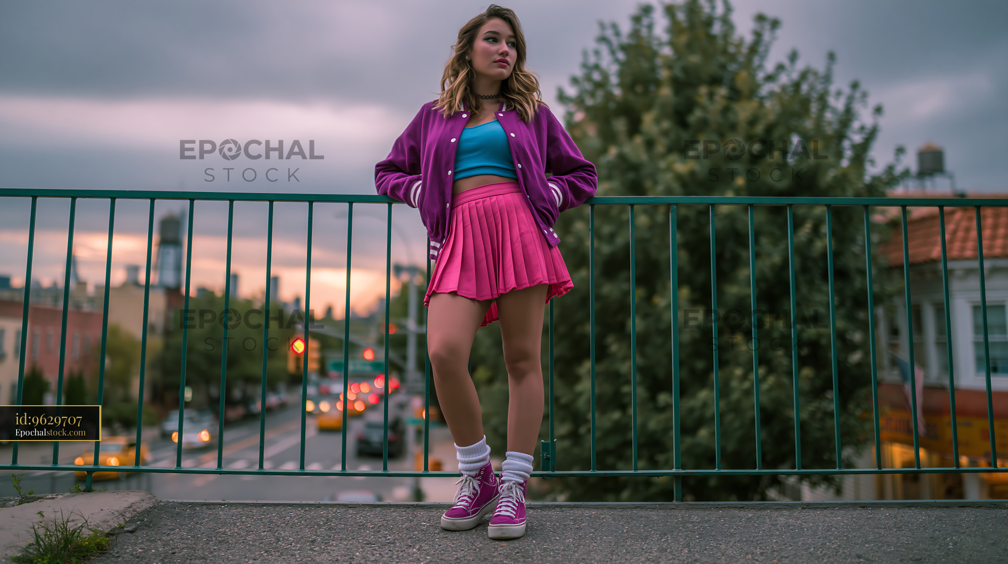 Watermarked full-resolution preview of Fashionable young woman on city bridge at dusk