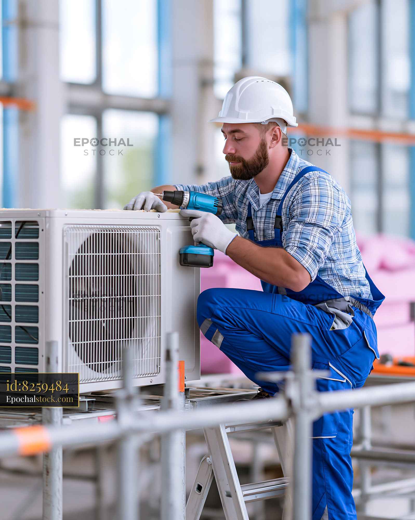 Watermarked full-resolution preview of Technician installing air conditioning unit in modern building