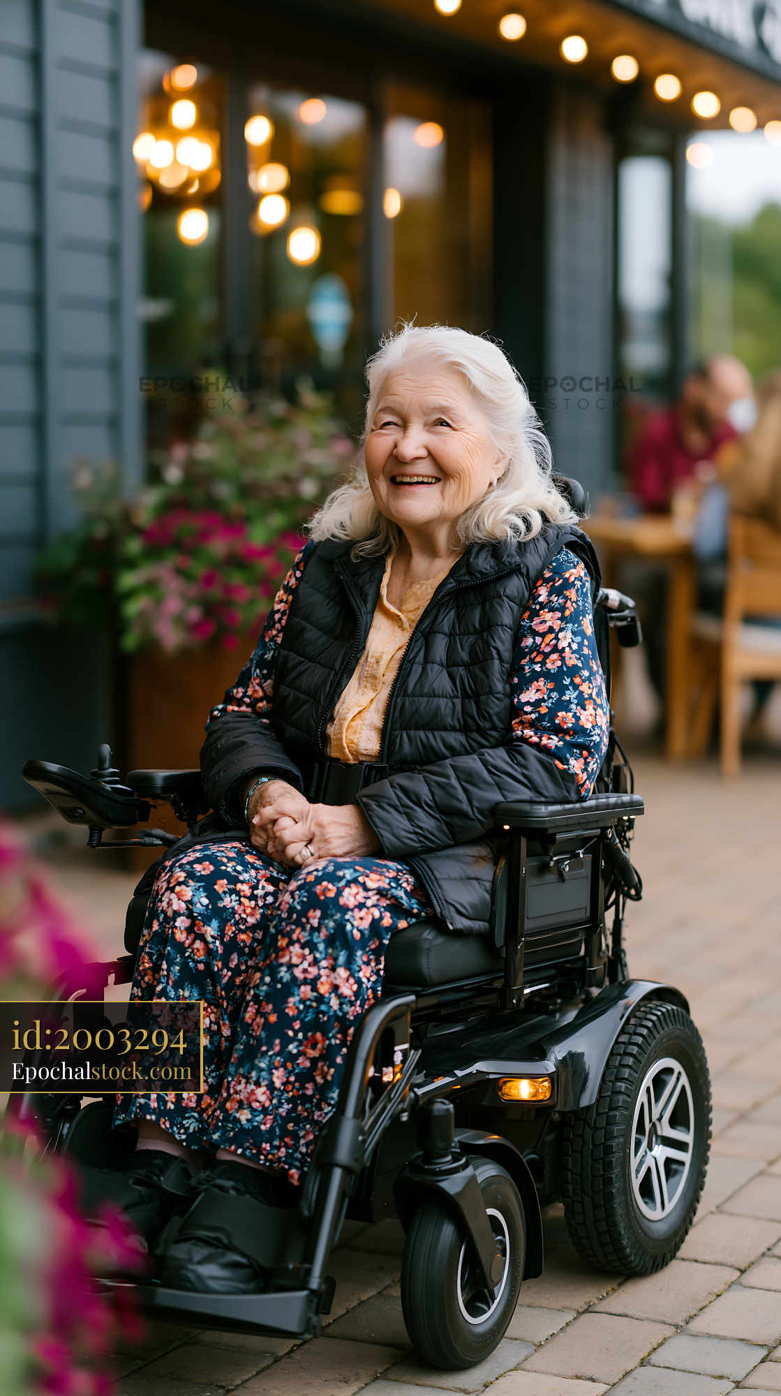 Watermarked full-resolution preview of Happy senior woman using a power wheelchair outdoors