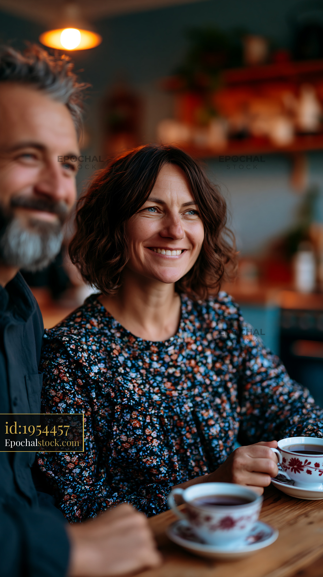 Watermarked full-resolution preview of Couple enjoying coffee together in a cozy cafe setting