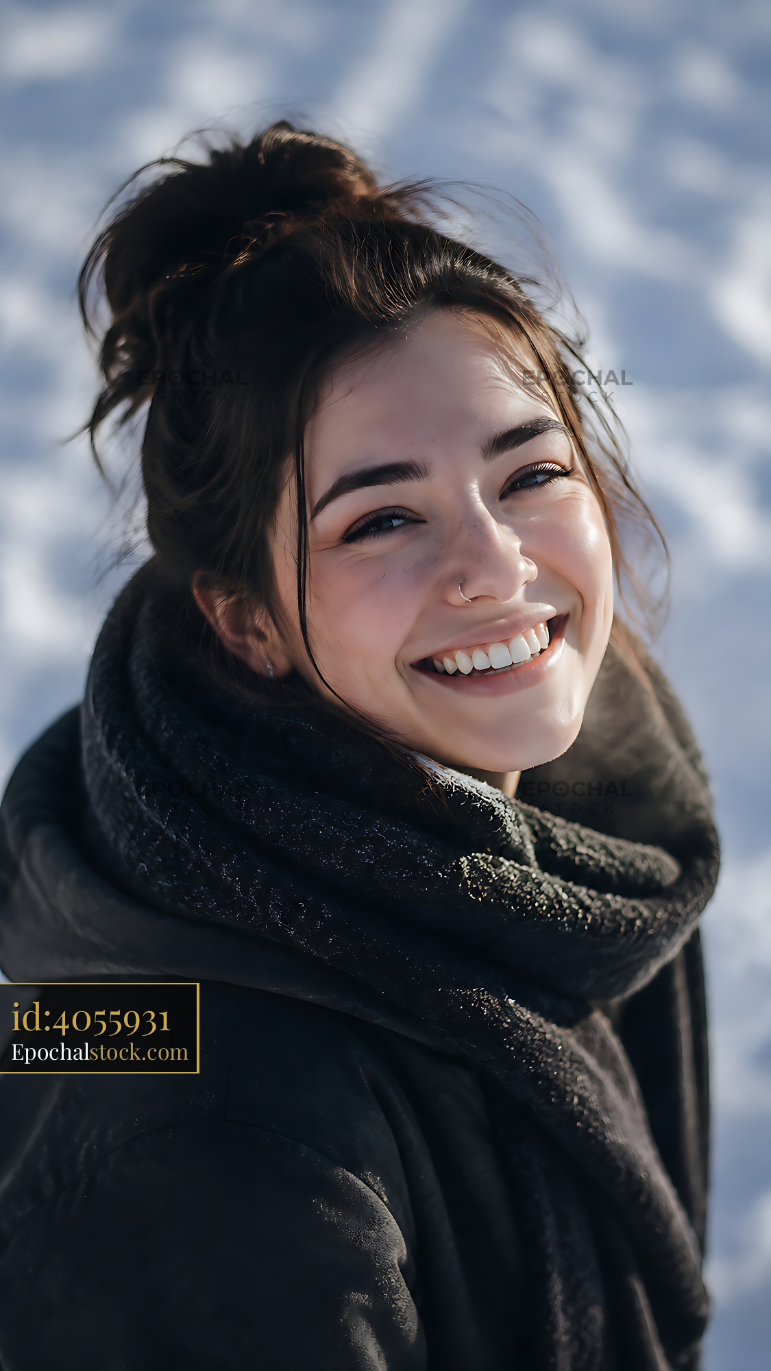 Young Woman Smiling in Winter Setting With Snow and Scarf - stock photo