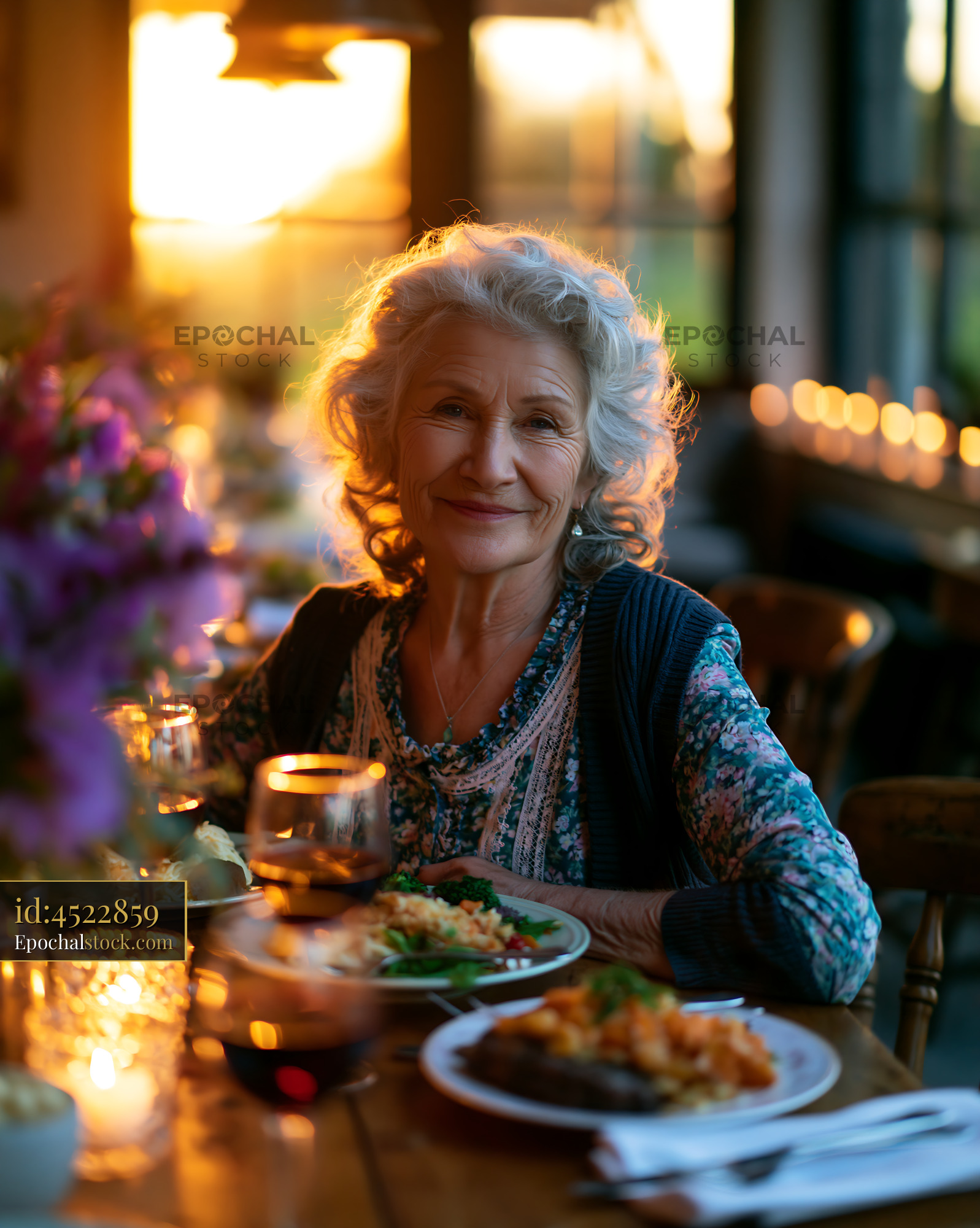 Watermarked full-resolution preview of Senior woman enjoying dinner during sunset gathering