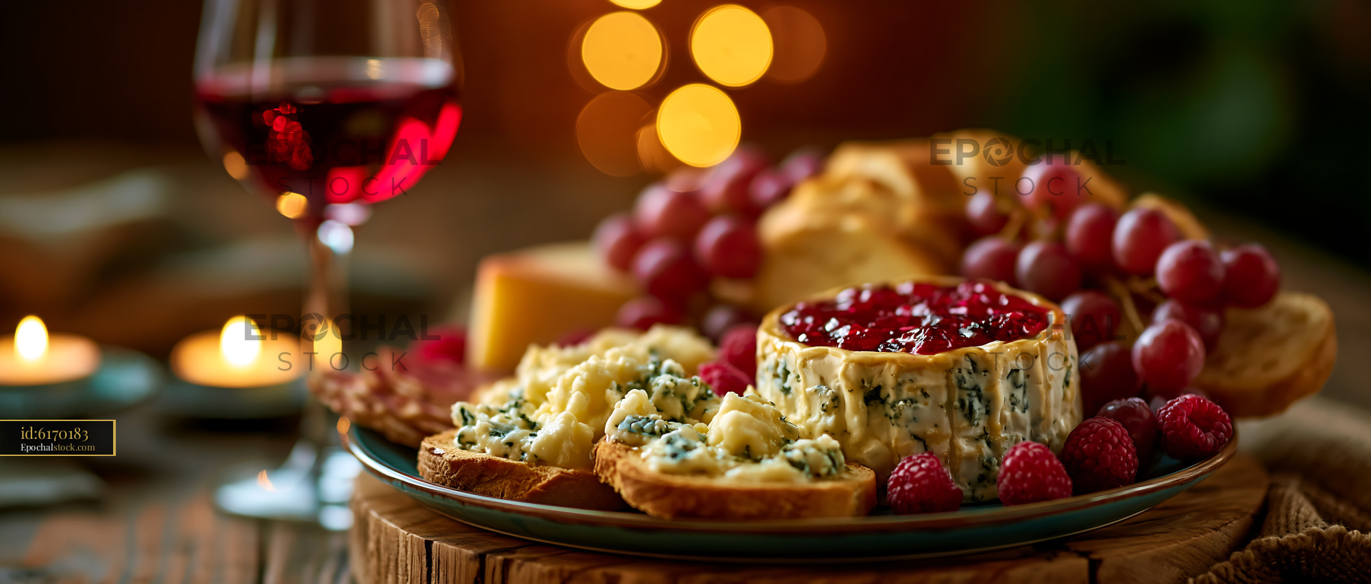 Watermarked full-resolution preview of Gourmet cheese board with wine and fruit in warm candlelight