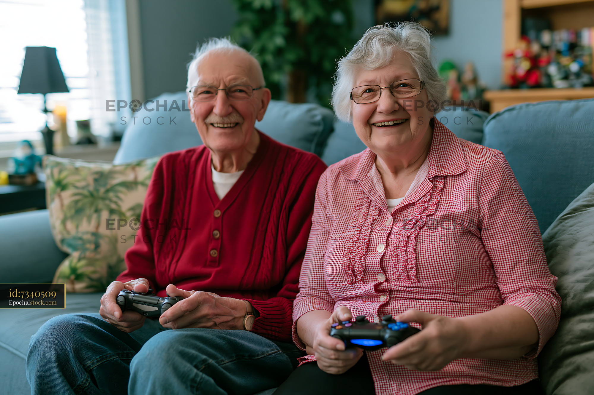 Watermarked full-resolution preview of Elderly couple playing video games on a couch