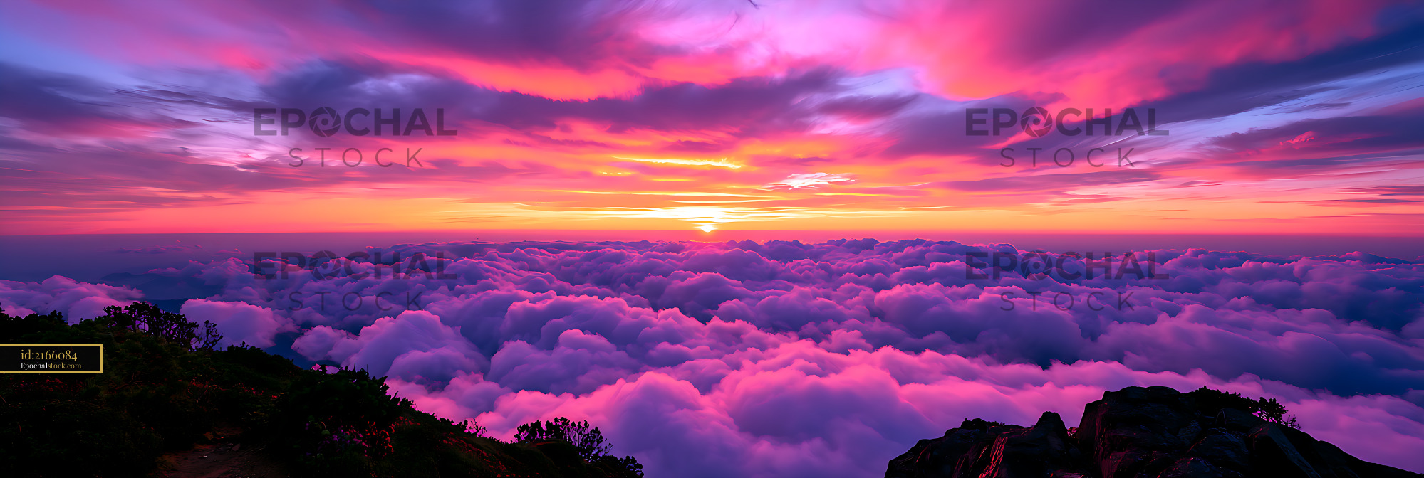 Watermarked full-resolution preview of Colorful sunset over clouds and rugged mountain foreground