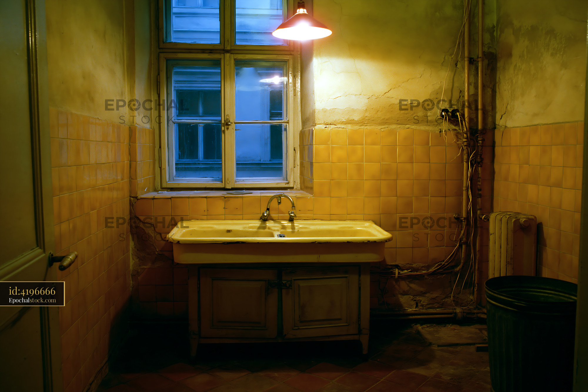 Watermarked full-resolution preview of Old bathroom with yellow tiles and a single sink in low light