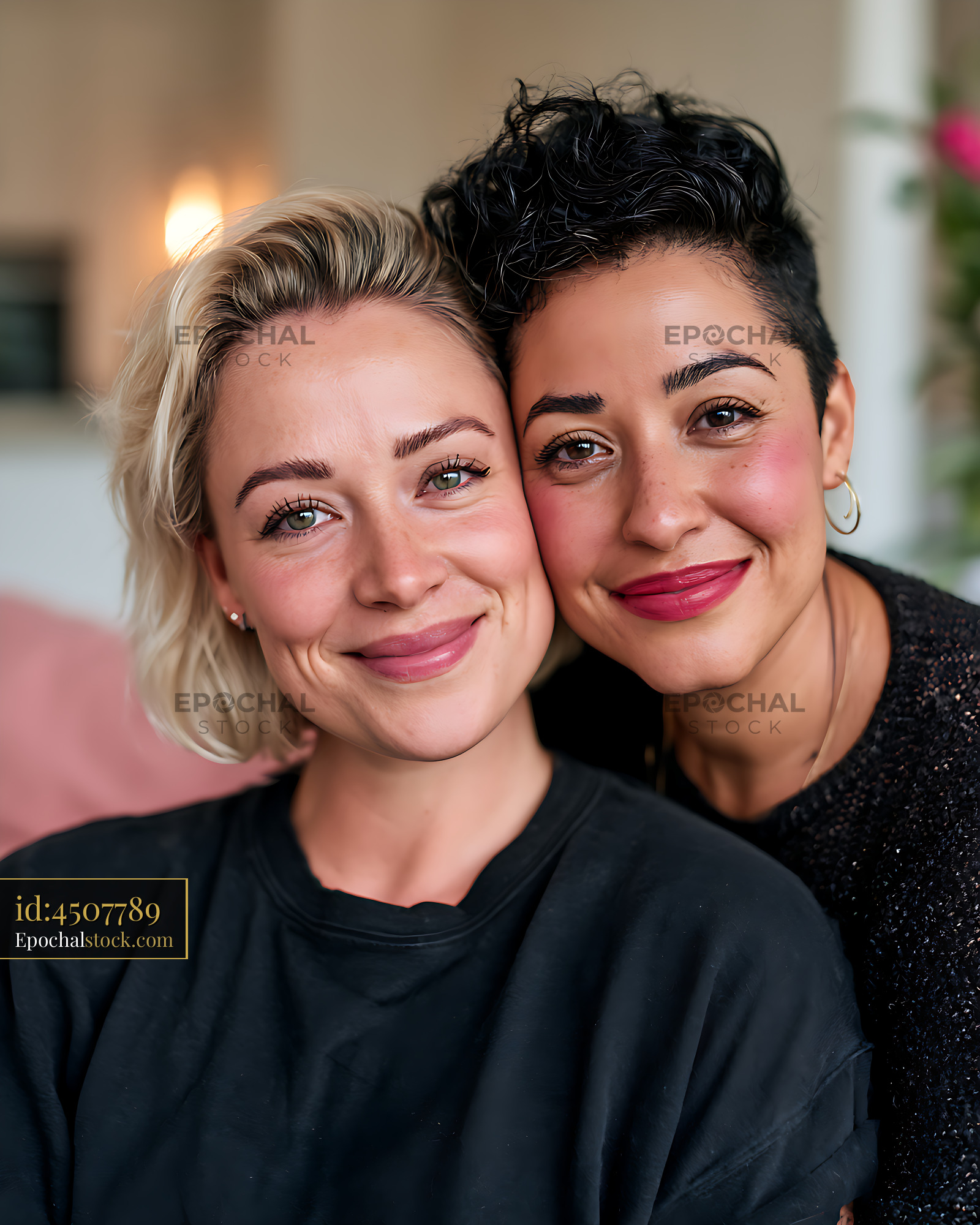 Watermarked full-resolution preview of Close portrait of two smiling women together indoors