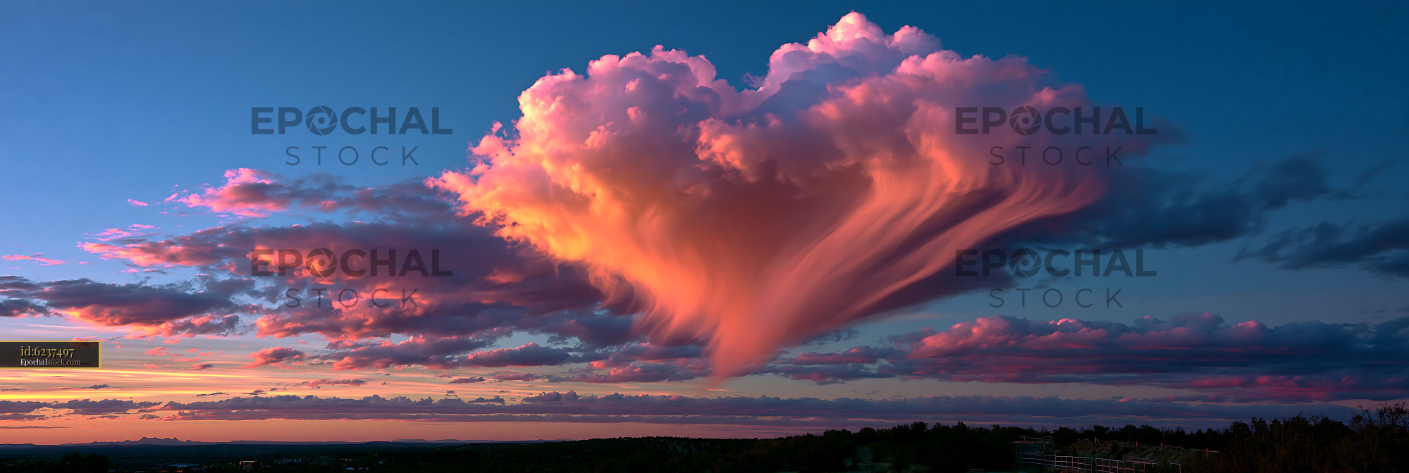 Watermarked full-resolution preview of Colorful sunset cloudscape above a distant horizon