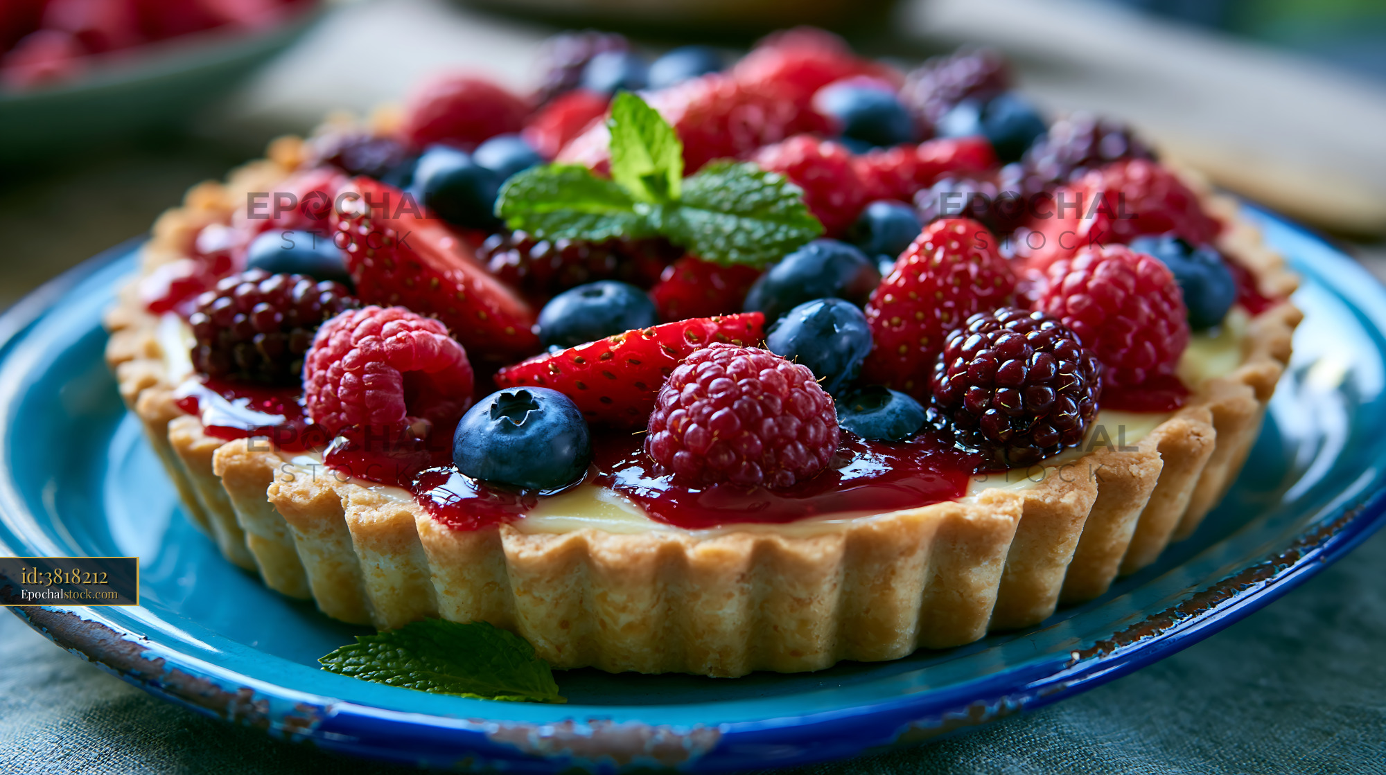 Watermarked full-resolution preview of Colorful berry tart topped with fresh fruit and mint