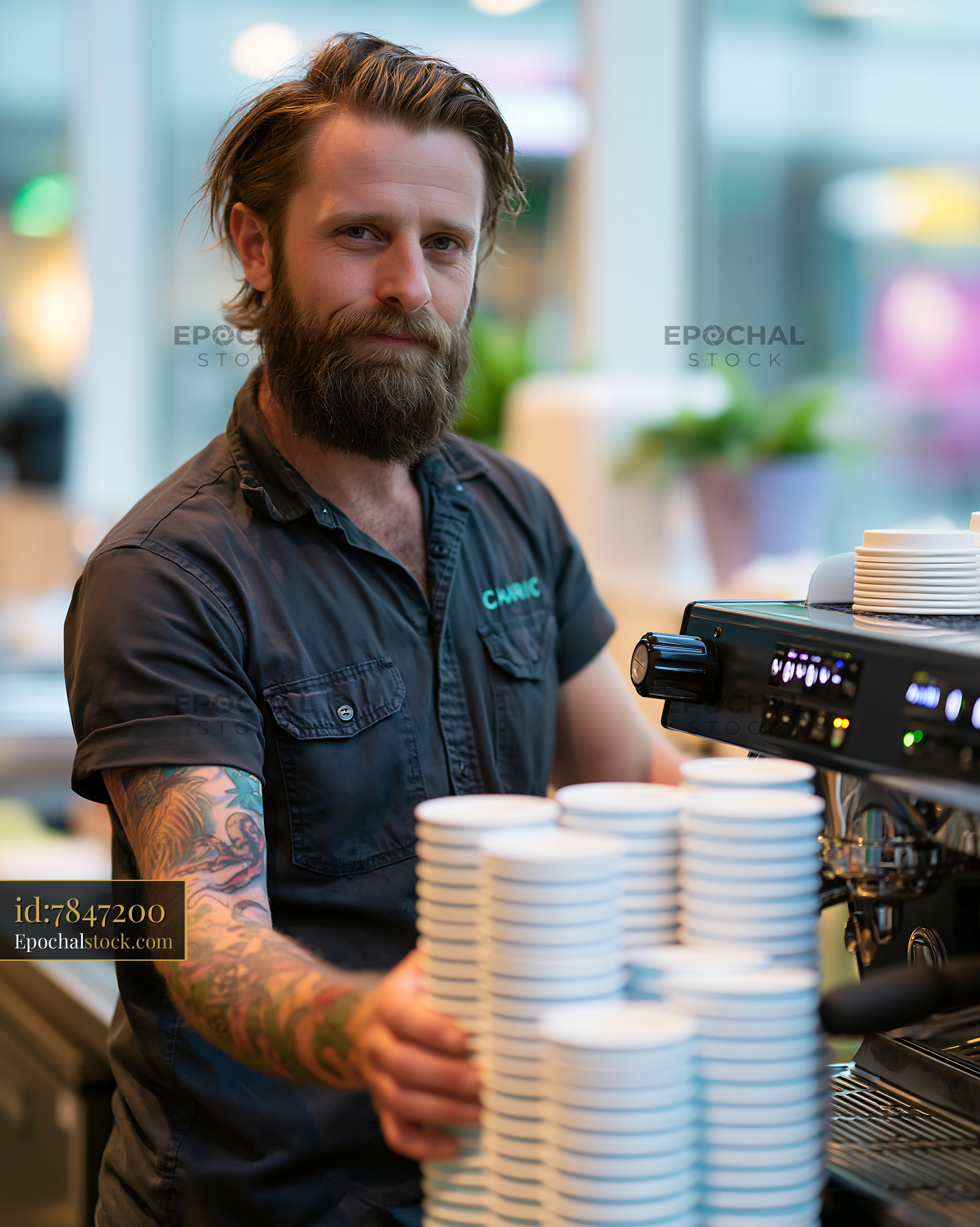 Watermarked full-resolution preview of Barista working with coffee cups in a cafe environment