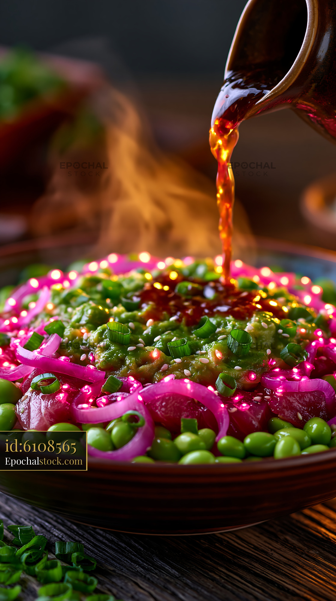 Watermarked full-resolution preview of Hot sauce is poured over colorful food in a wooden bowl