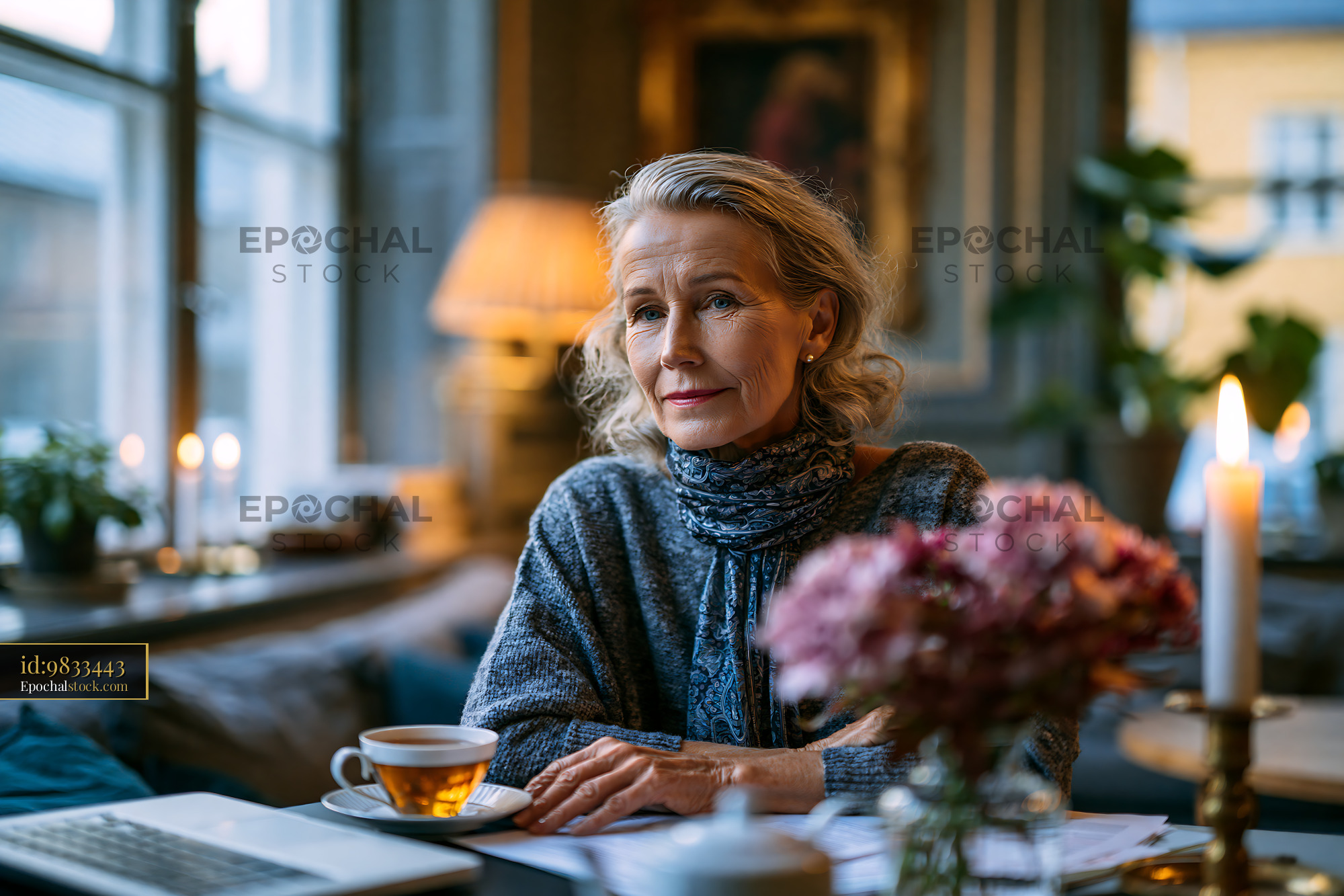 Watermarked full-resolution preview of Woman sitting in cafe with tea and flowers during evening