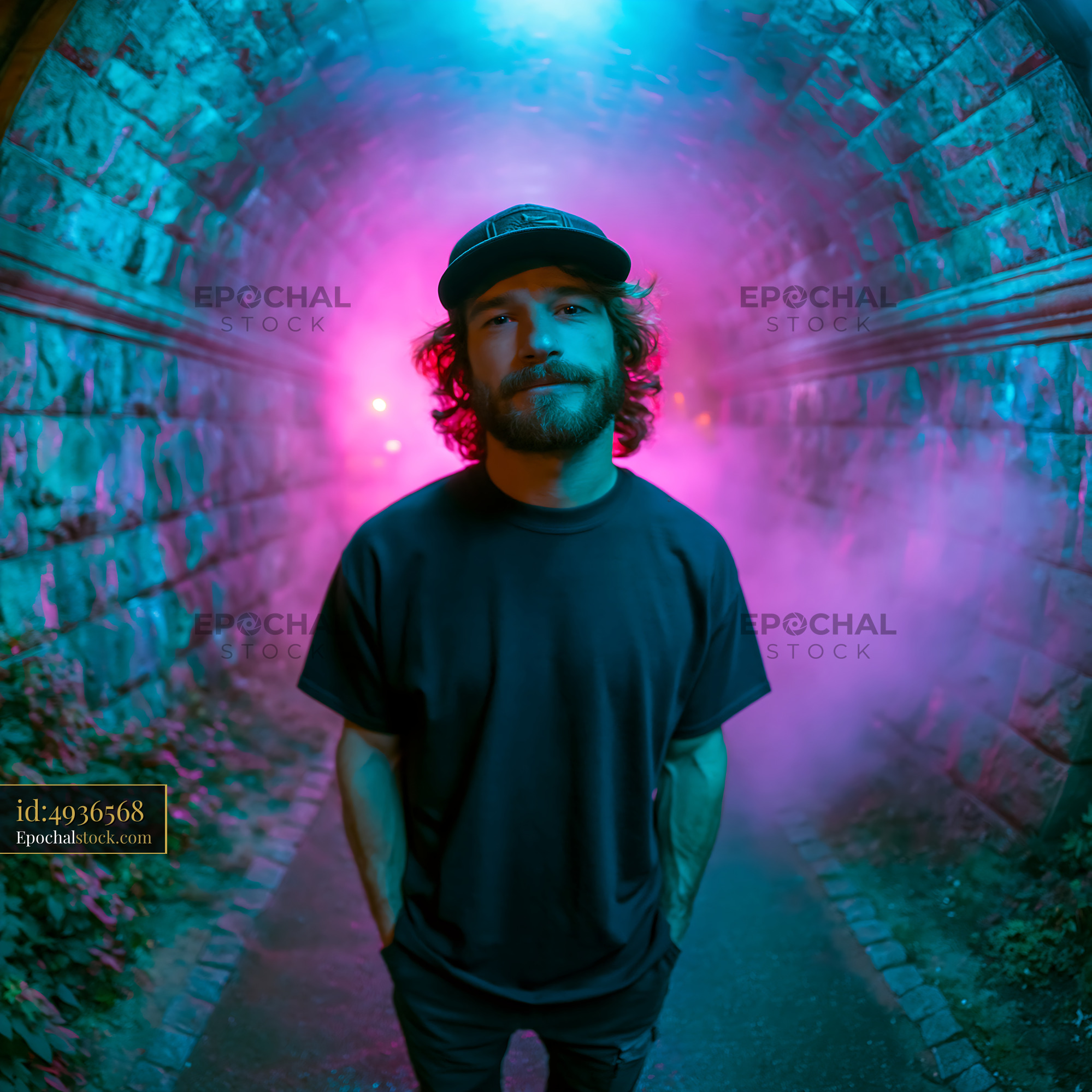 Skater Man in a Colorful Tunnel With Fog and Lights at Night - stock photo