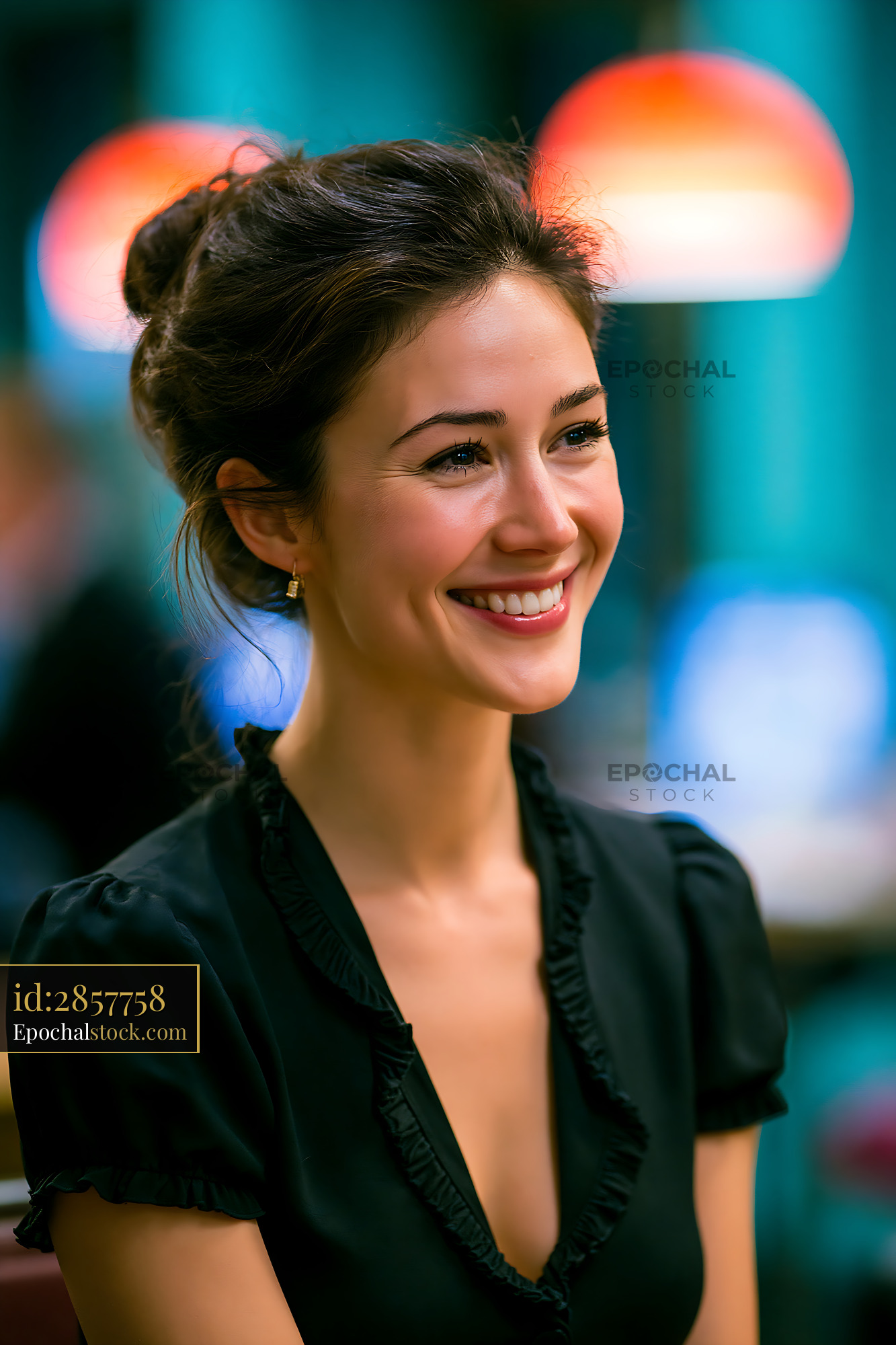 Watermarked full-resolution preview of Smiling woman in black top sitting at cafe