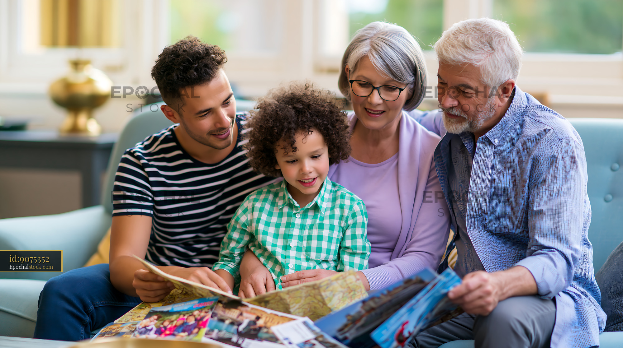 Watermarked full-resolution preview of Family enjoying time together while looking at photo albums