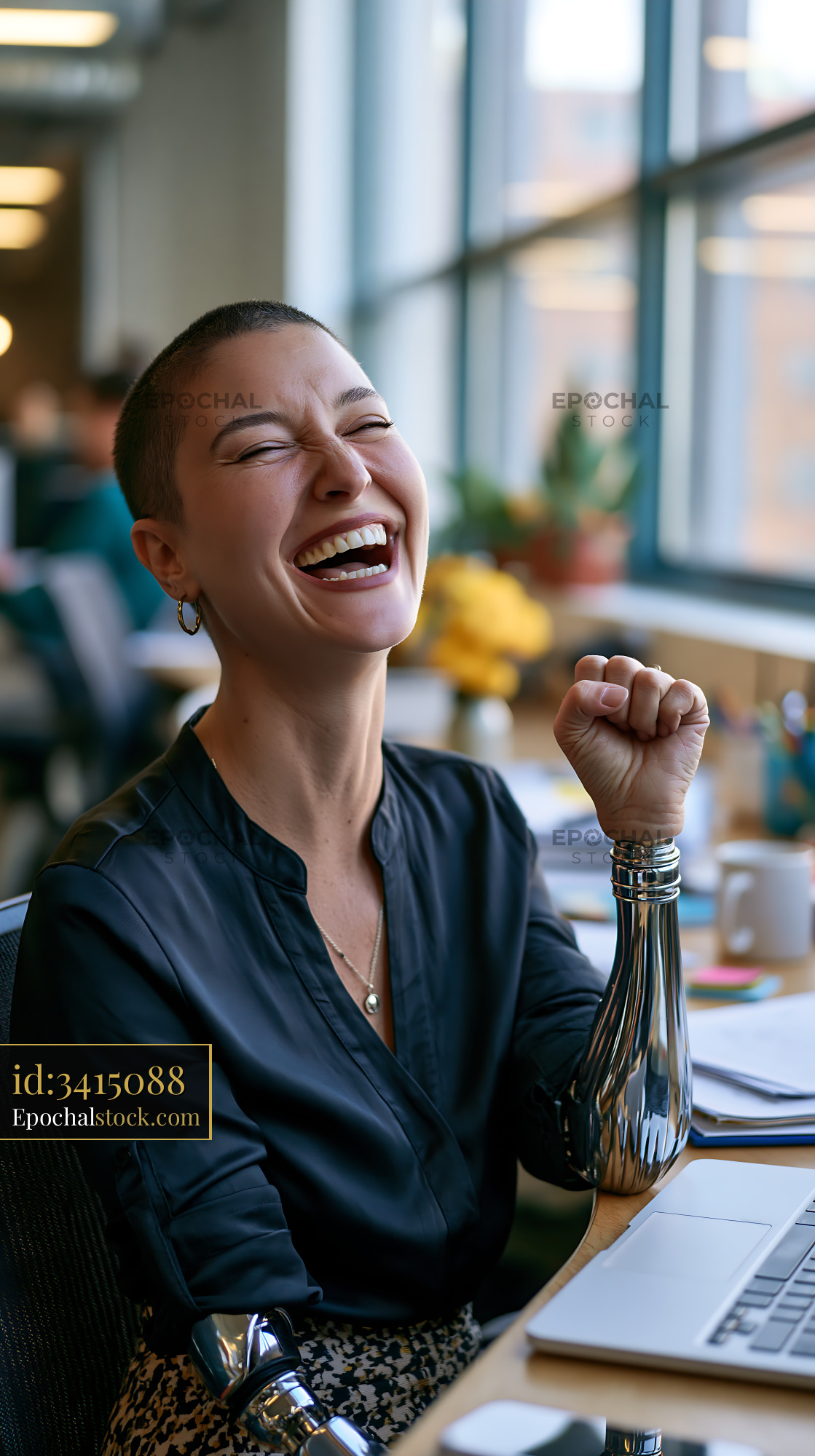 Watermarked full-resolution preview of Woman with prosthetic arms laughing in a modern office environment