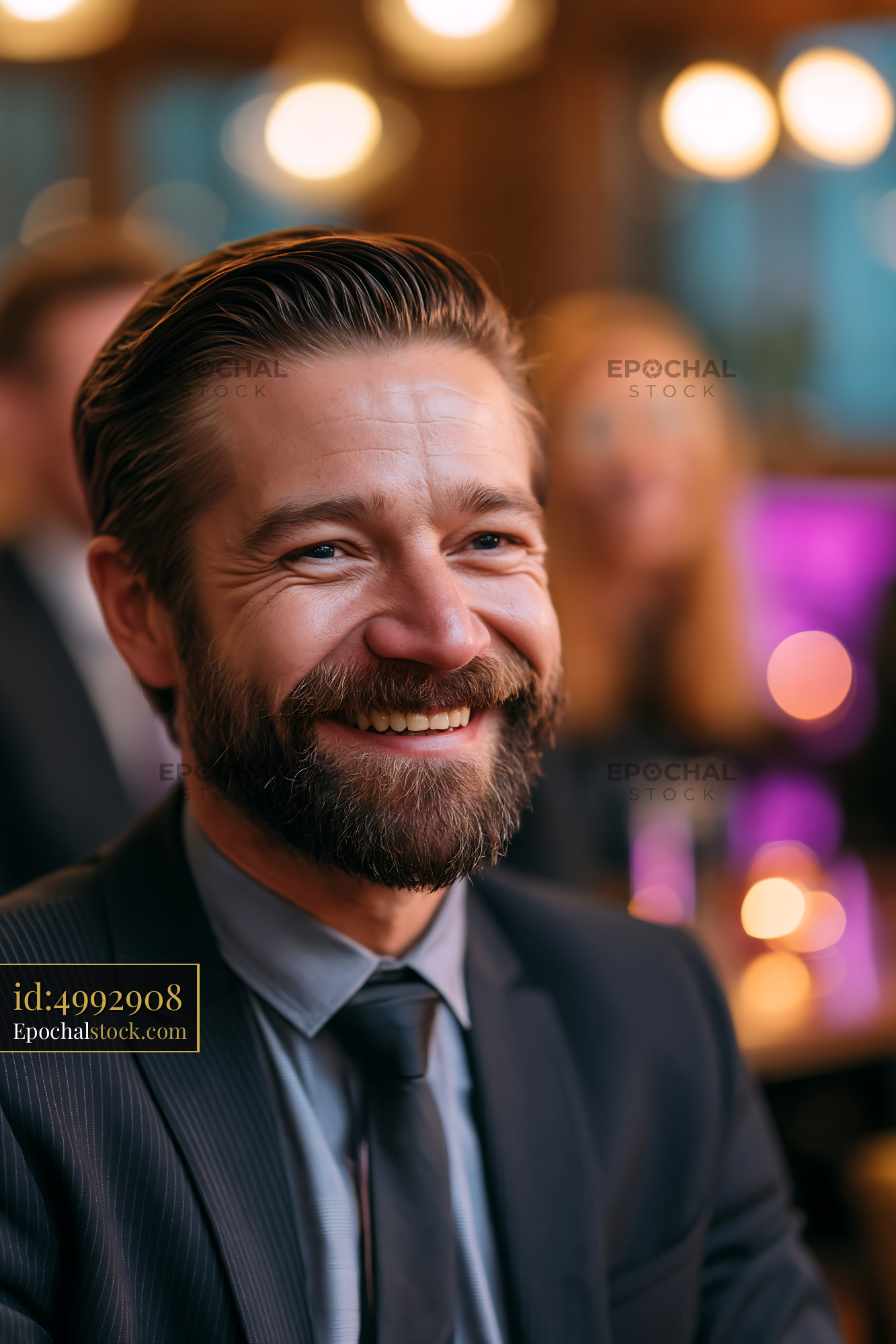 Watermarked full-resolution preview of Smiling man in suit at a social event