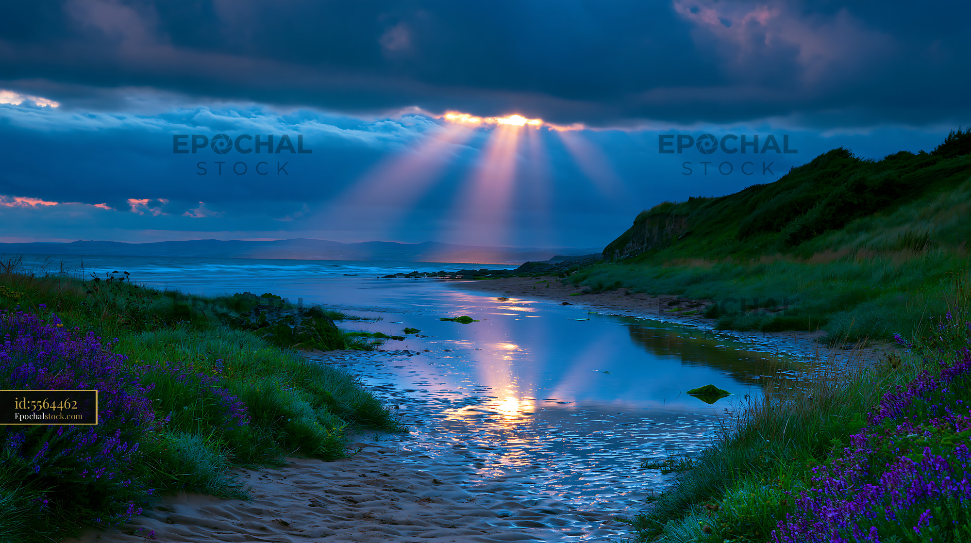 Watermarked full-resolution preview of Sunlight breaks through clouds over a shoreline at dusk