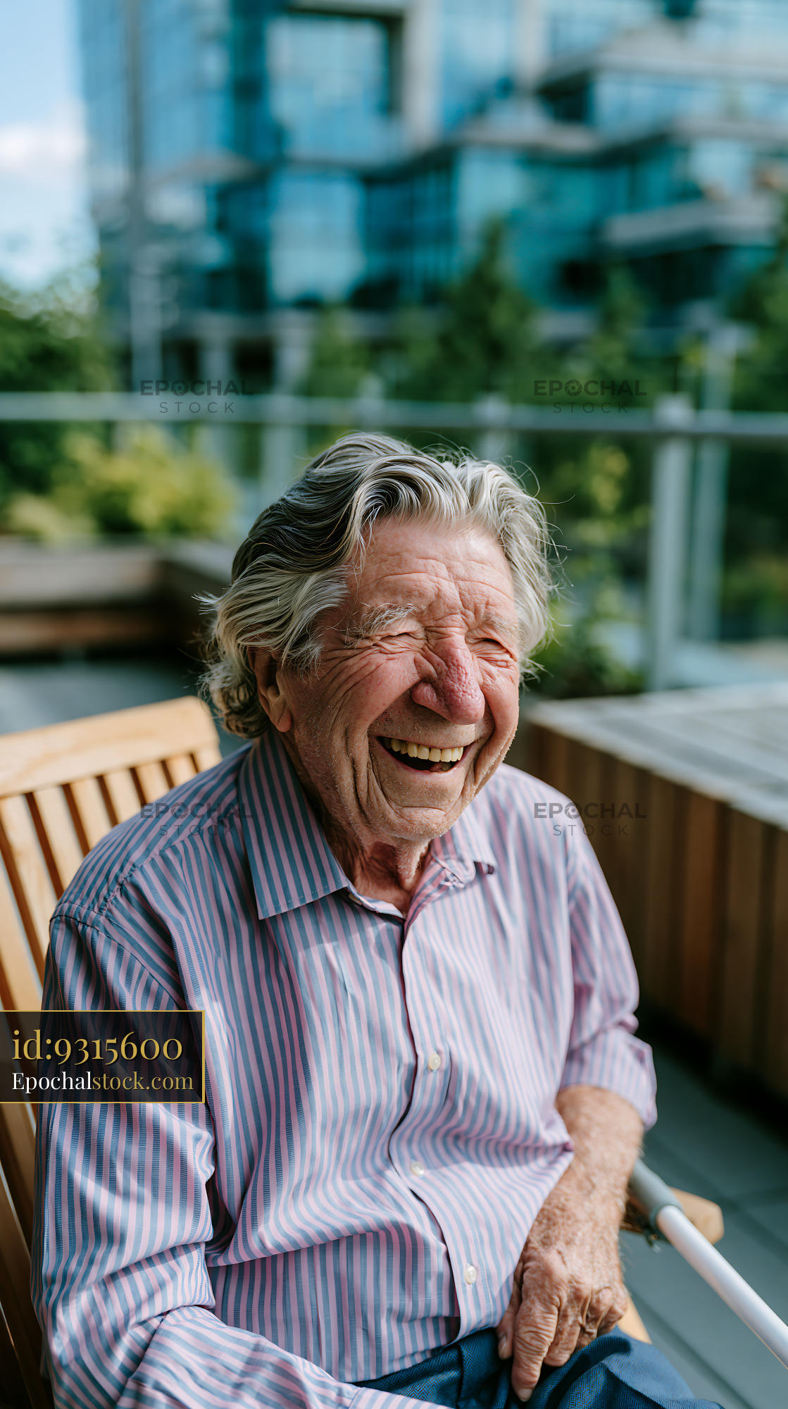 Watermarked full-resolution preview of Older man smiles while sitting on a bench in outdoor setting