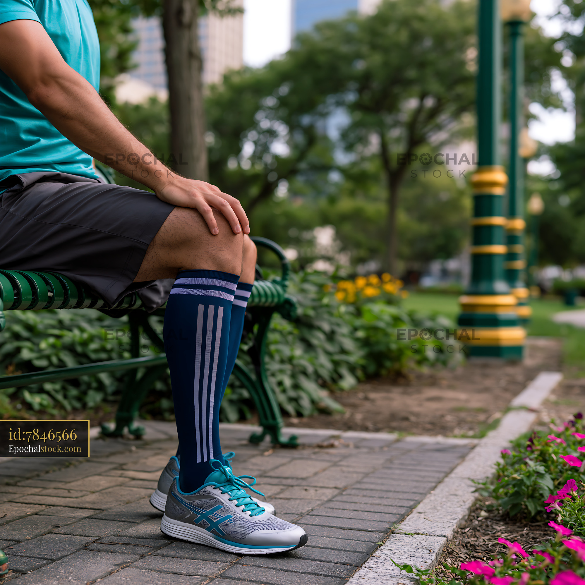 Watermarked full-resolution preview of Man resting on park bench with sportswear and sneakers