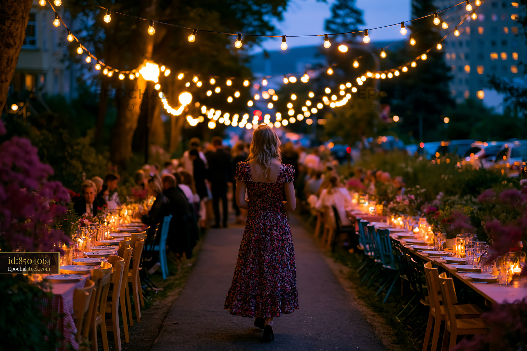 Watermarked full-resolution preview of Evening outdoor dining event with string lights and guests